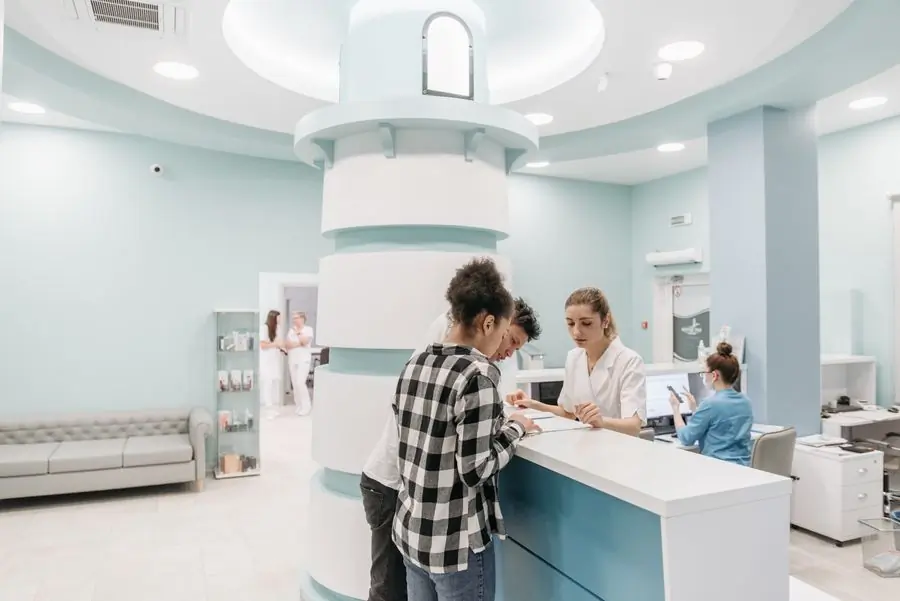 A patient registering at the hospital's outpatient desk