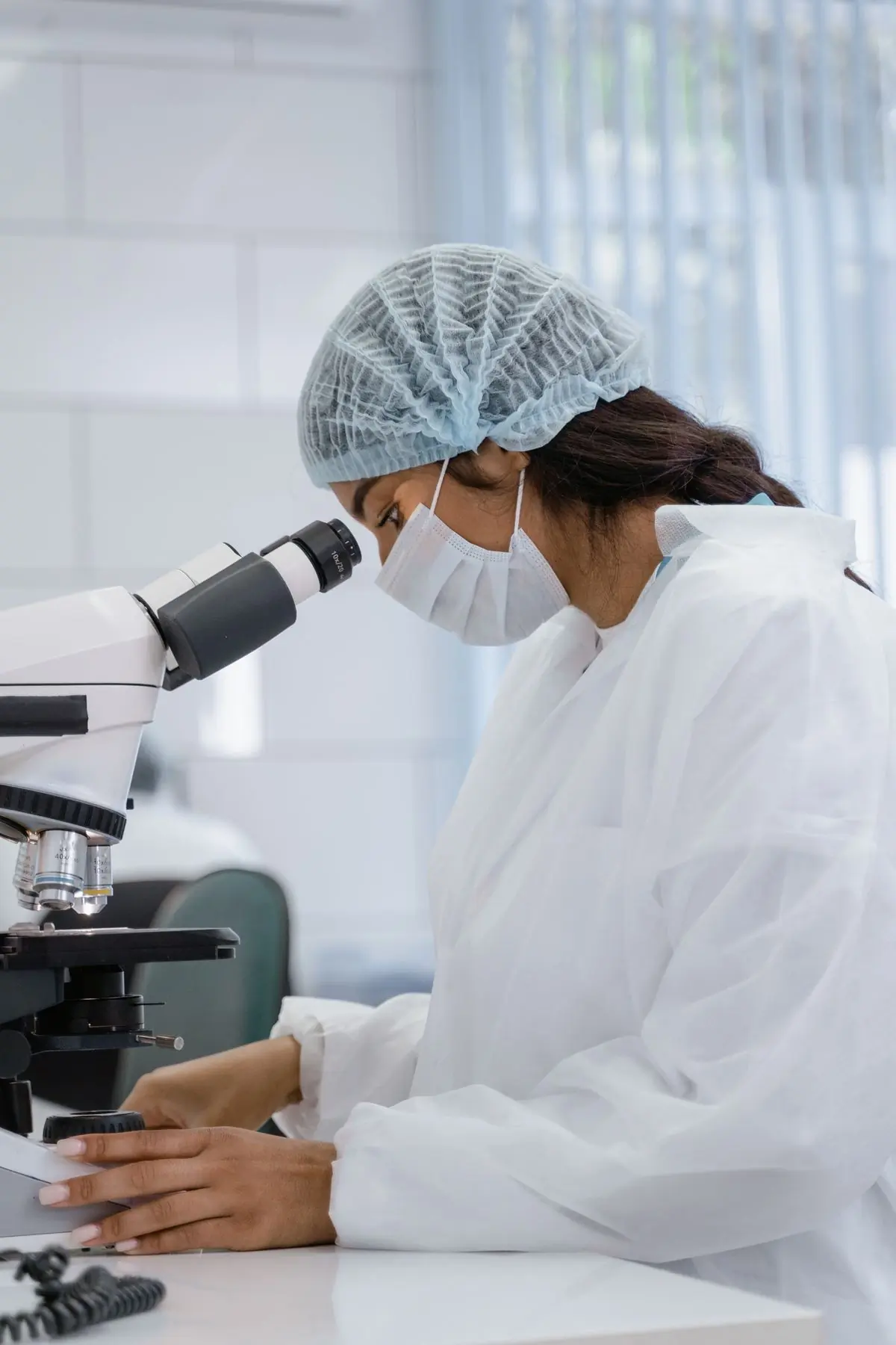 A technologist reading a slide in the hospital's own laboratory