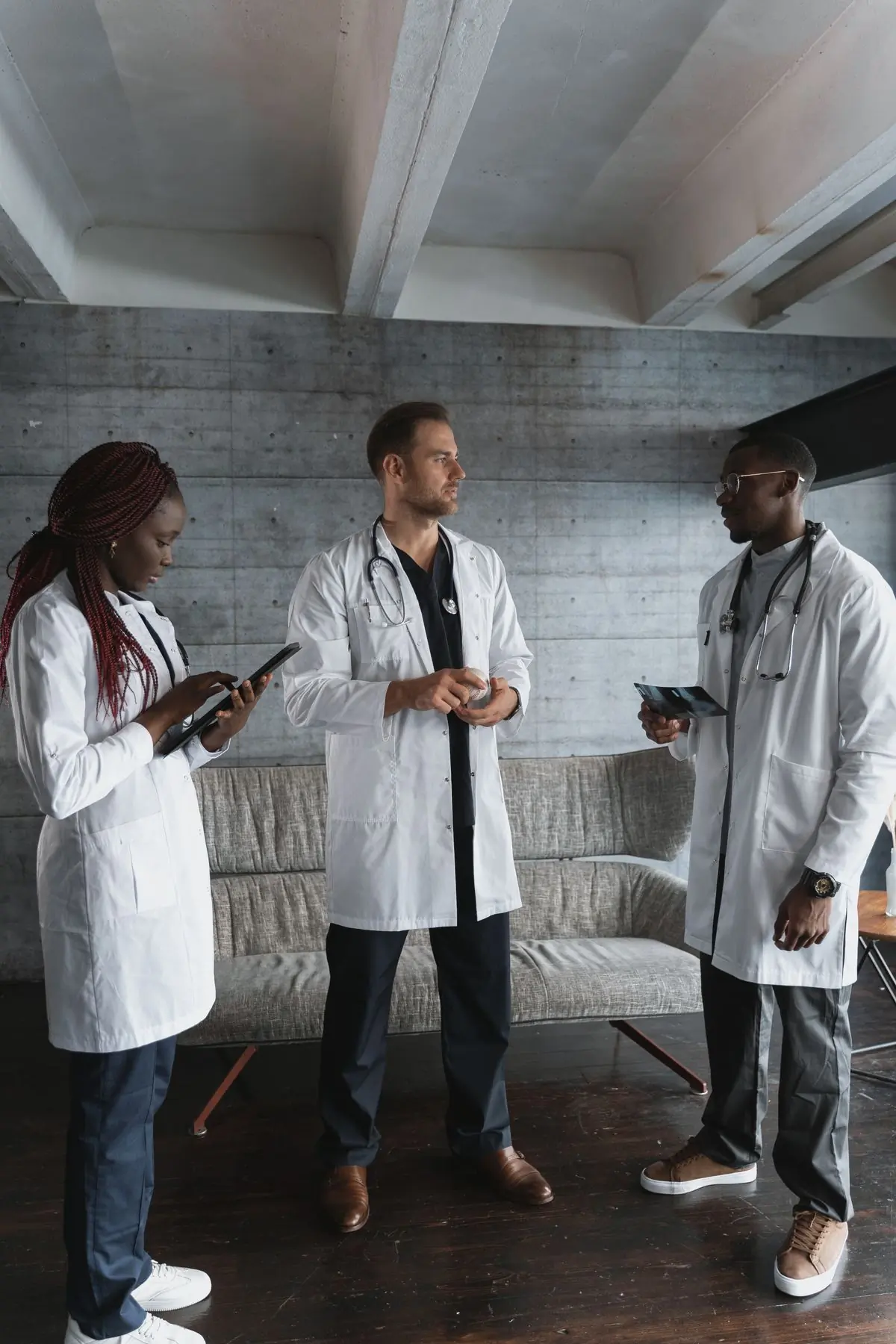 Three of the hospital's clinicians talking through a case