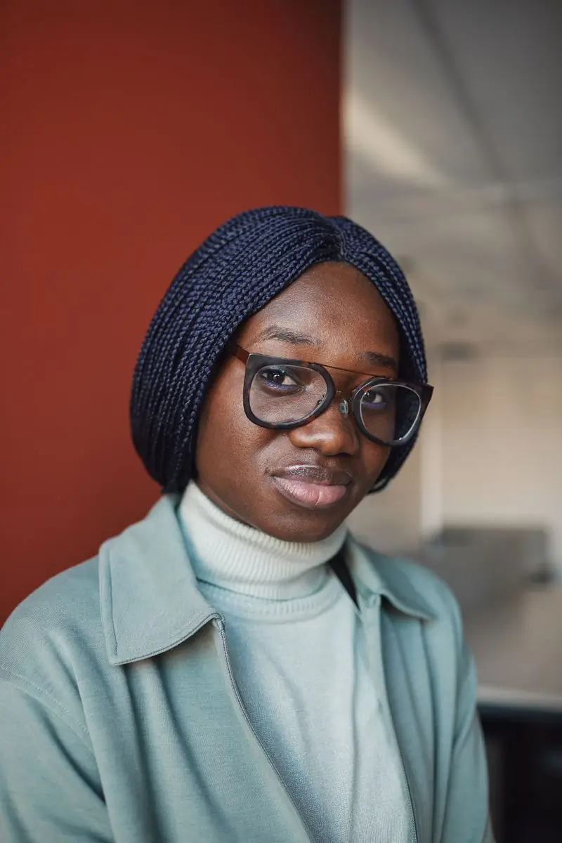 A woman in a turban wearing dark optical frames
