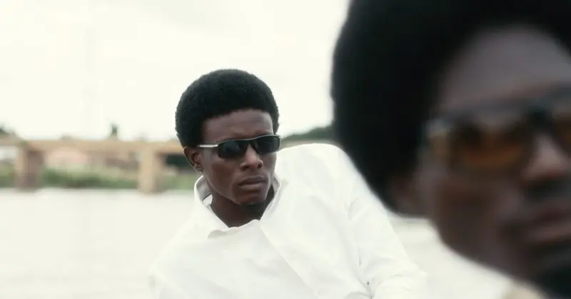 A man in dark sunglasses outdoors