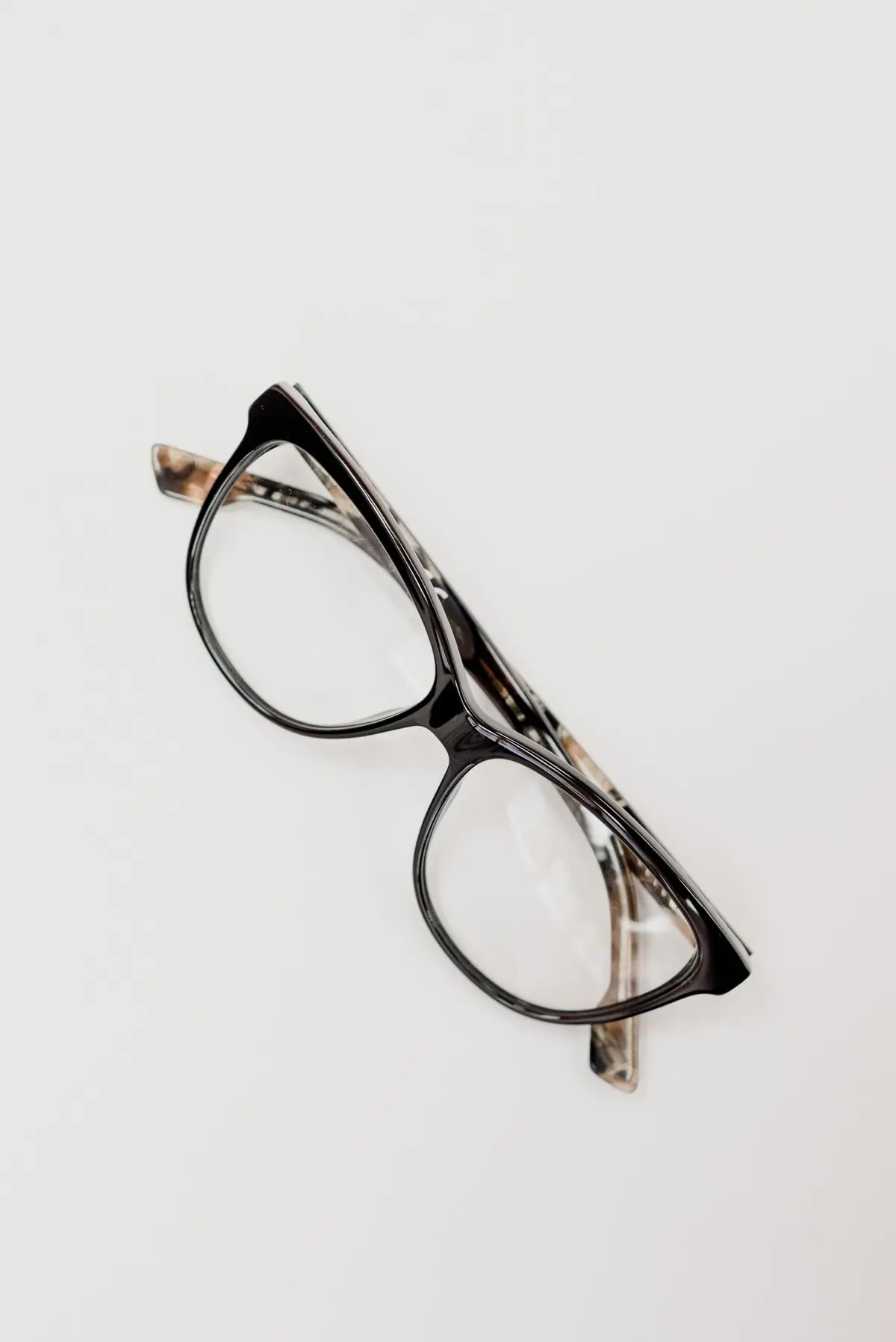 Dark acetate optical frames on a pale grey ground