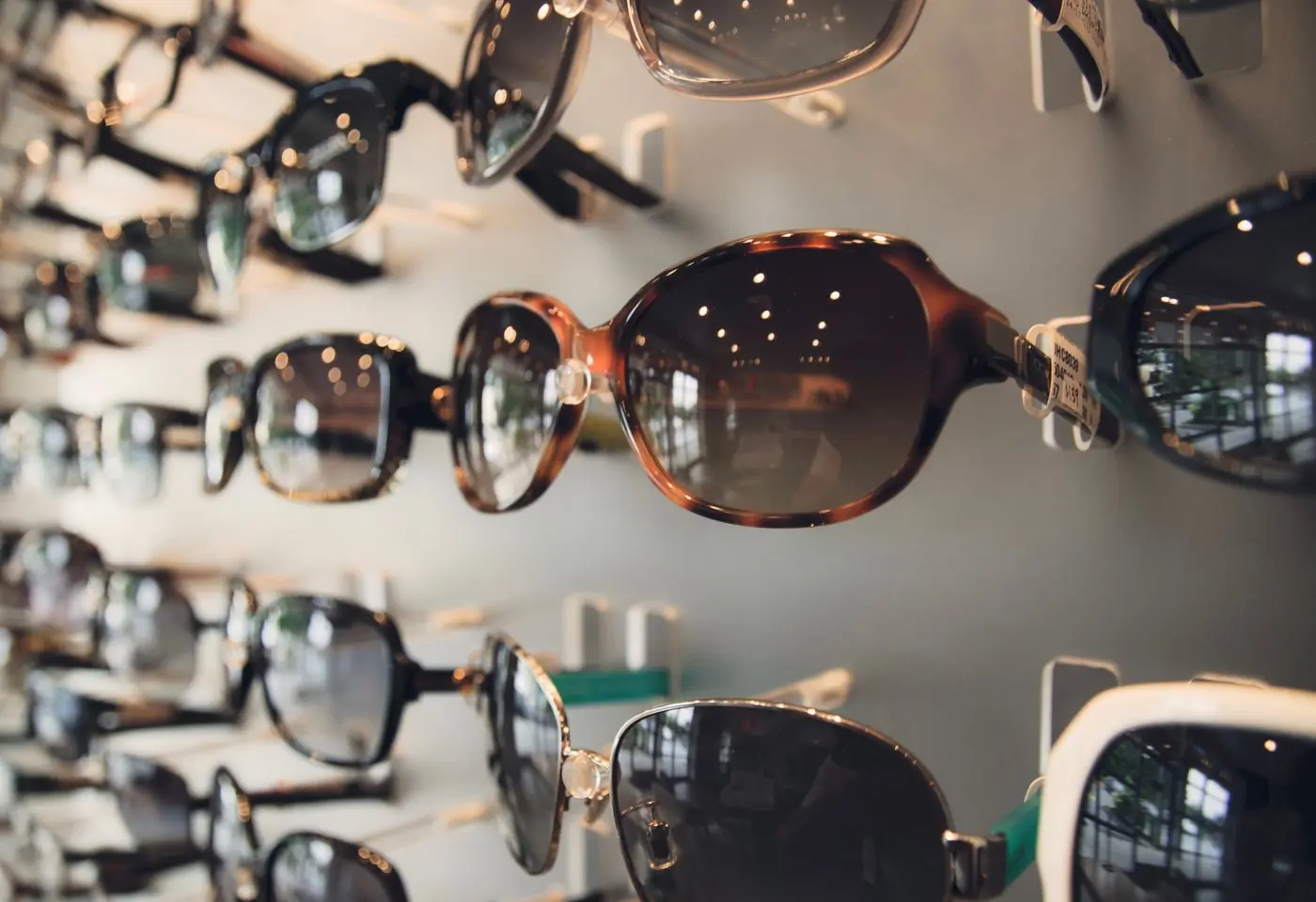 Tortoiseshell sunglasses displayed in a warm-lit cabinet