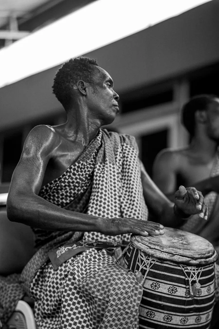 A drummer mid-performance in Accra