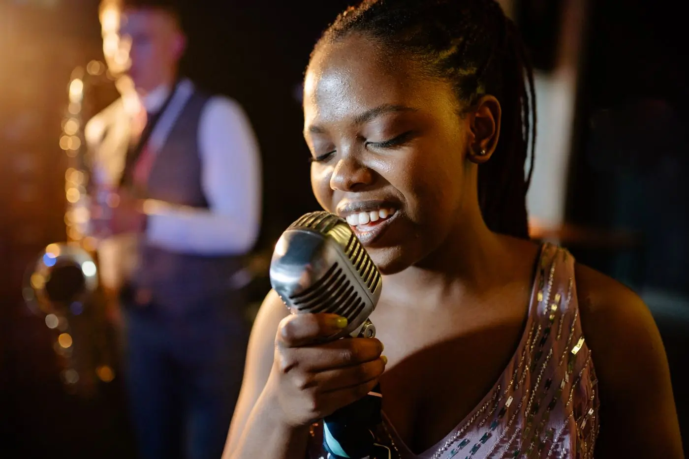 A vocalist singing with a live band behind her
