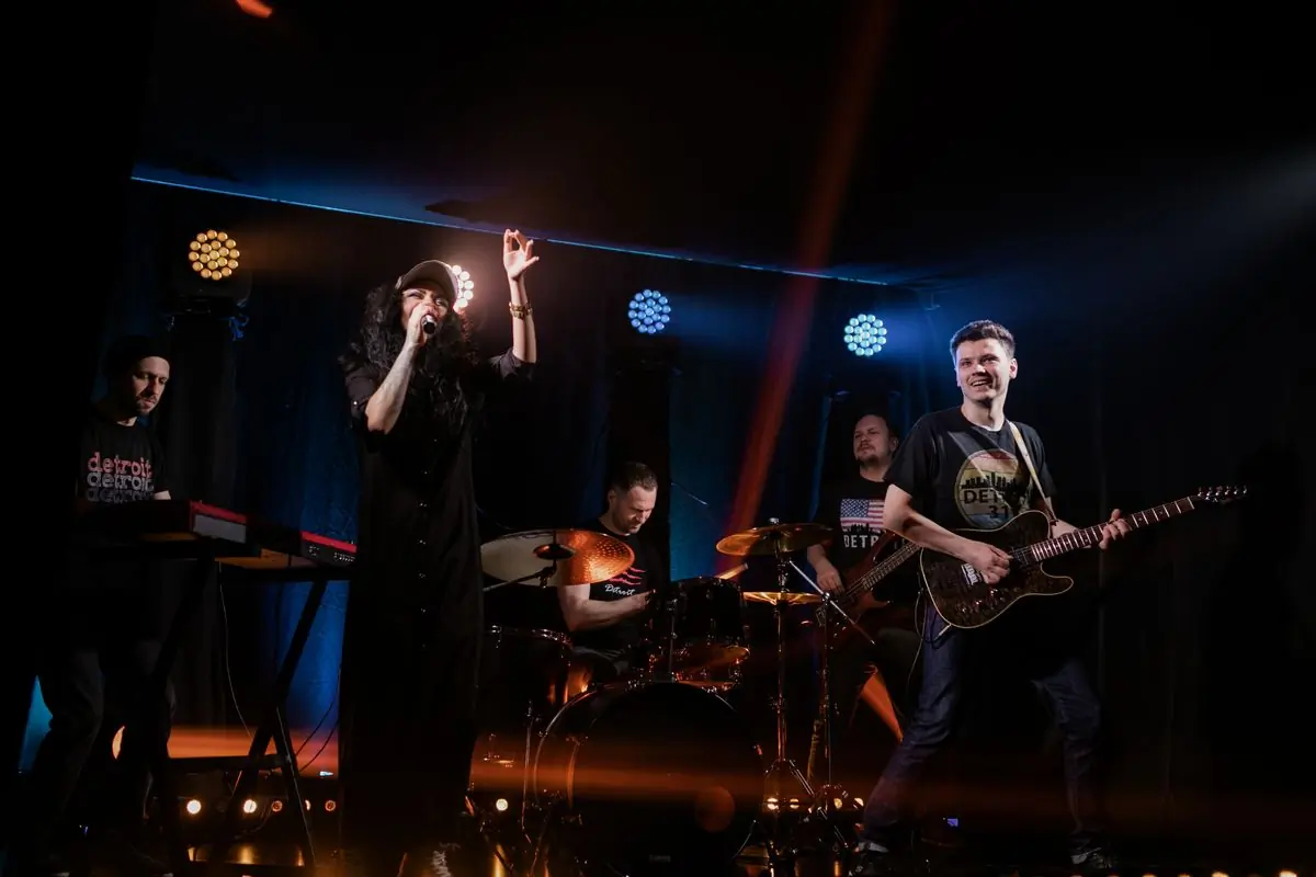 A band performing together on a lit stage