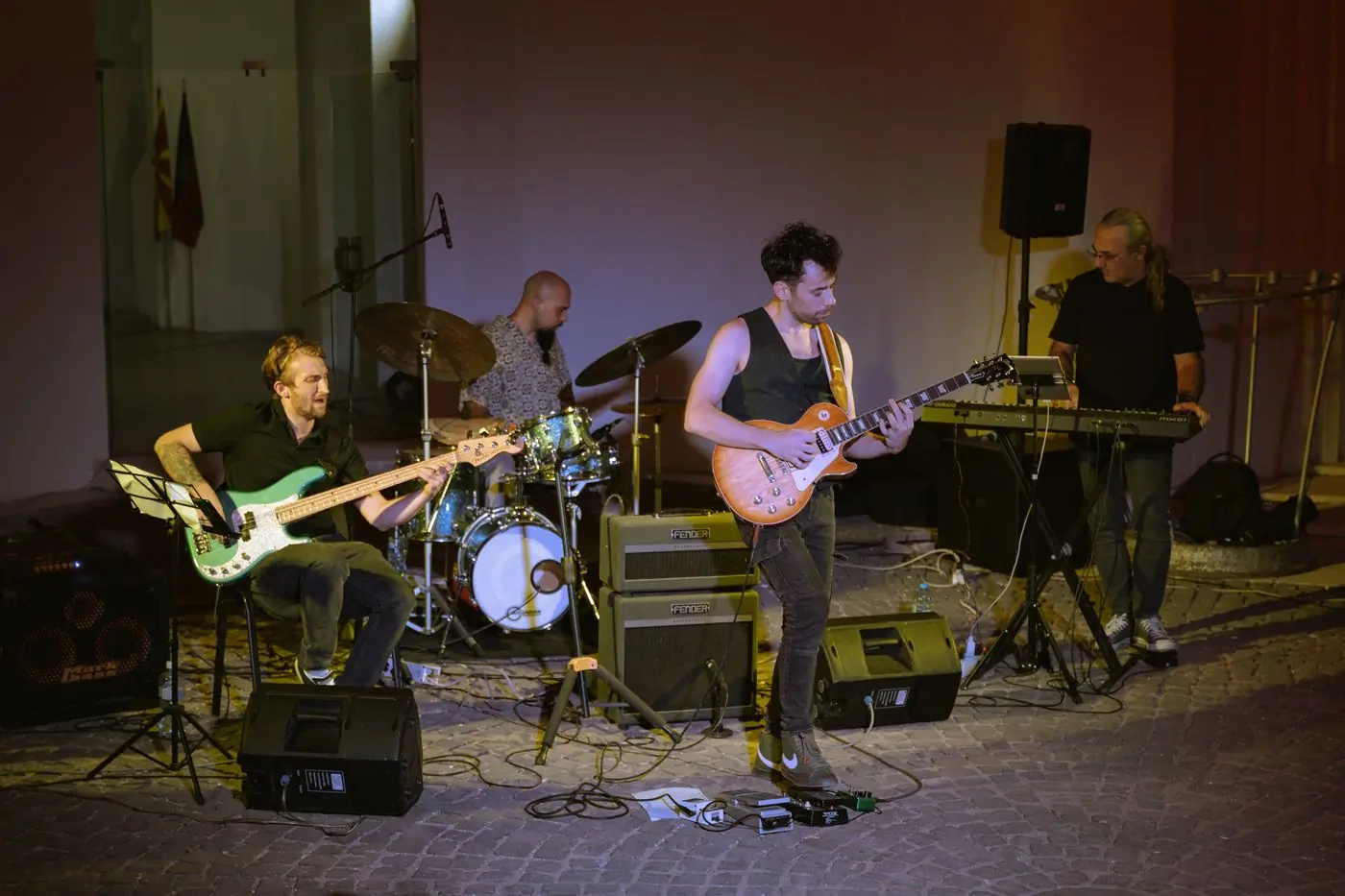 A band rehearsing together in a rehearsal room