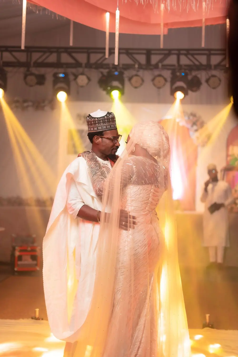 A couple dancing at a wedding reception in traditional dress