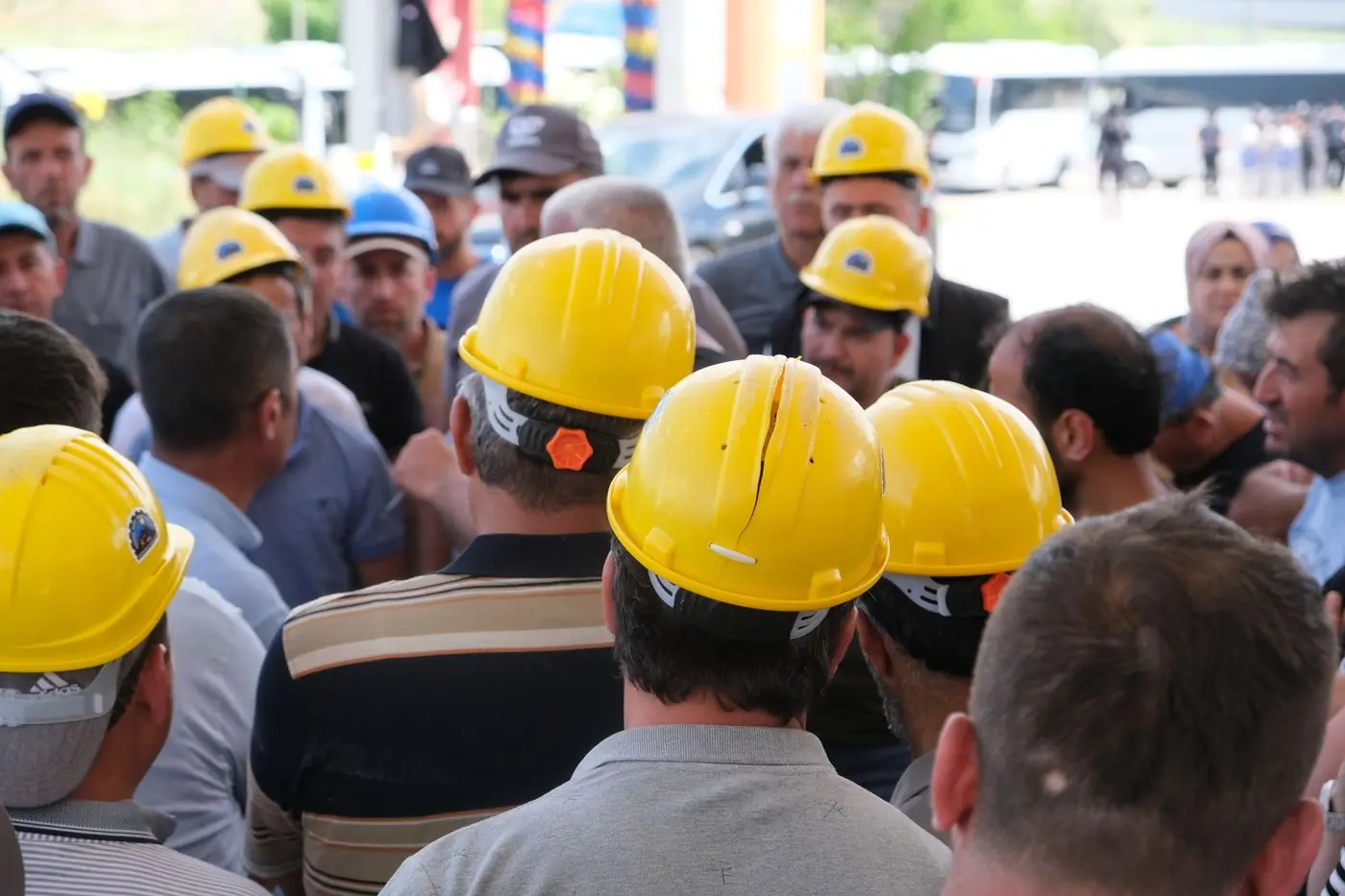 A site crew in yellow helmets at a briefing