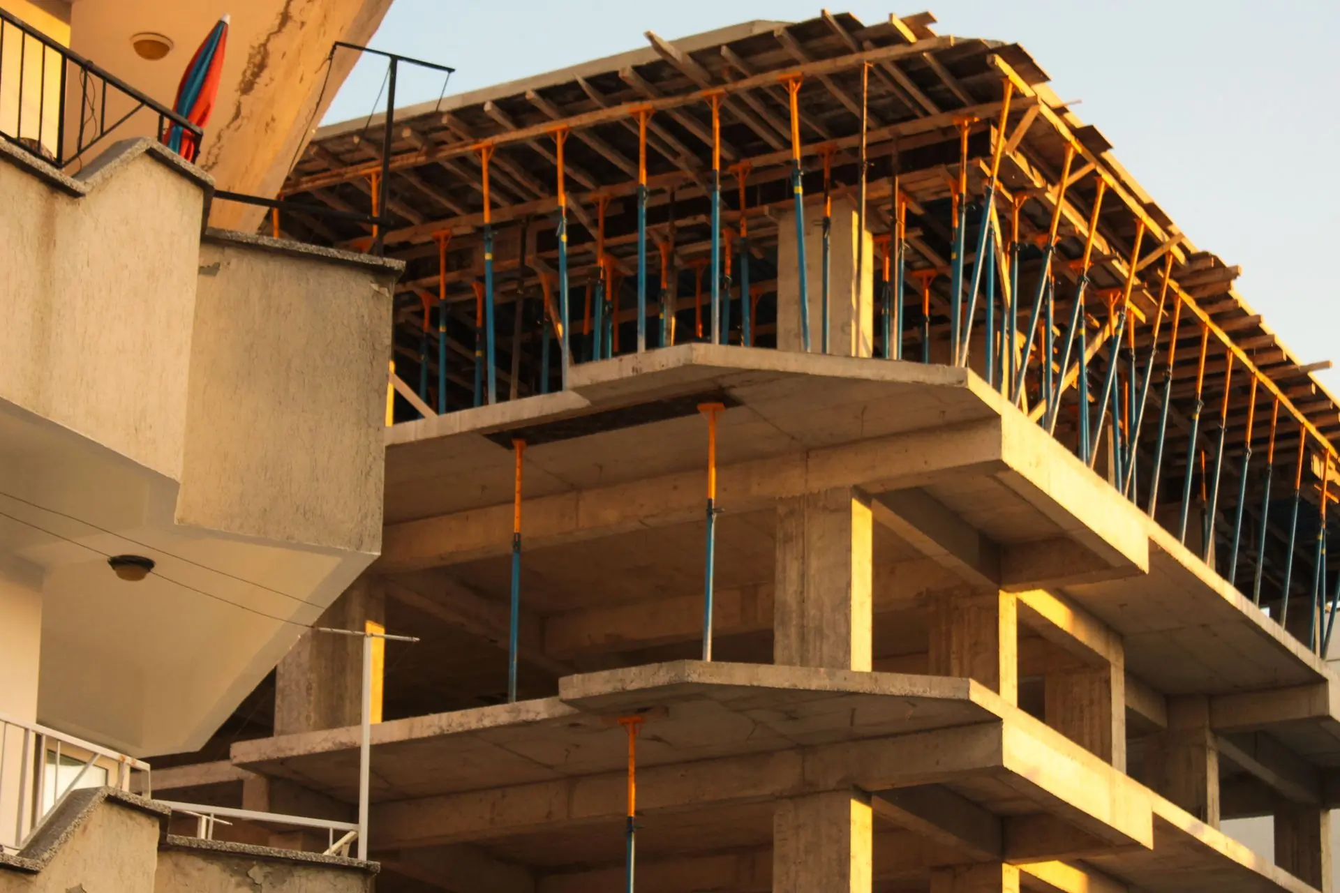 A concrete frame rising at sunset