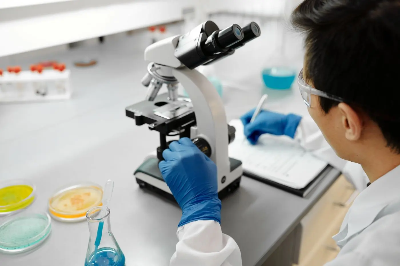 A laboratory scientist reading a slide at the centre's bench