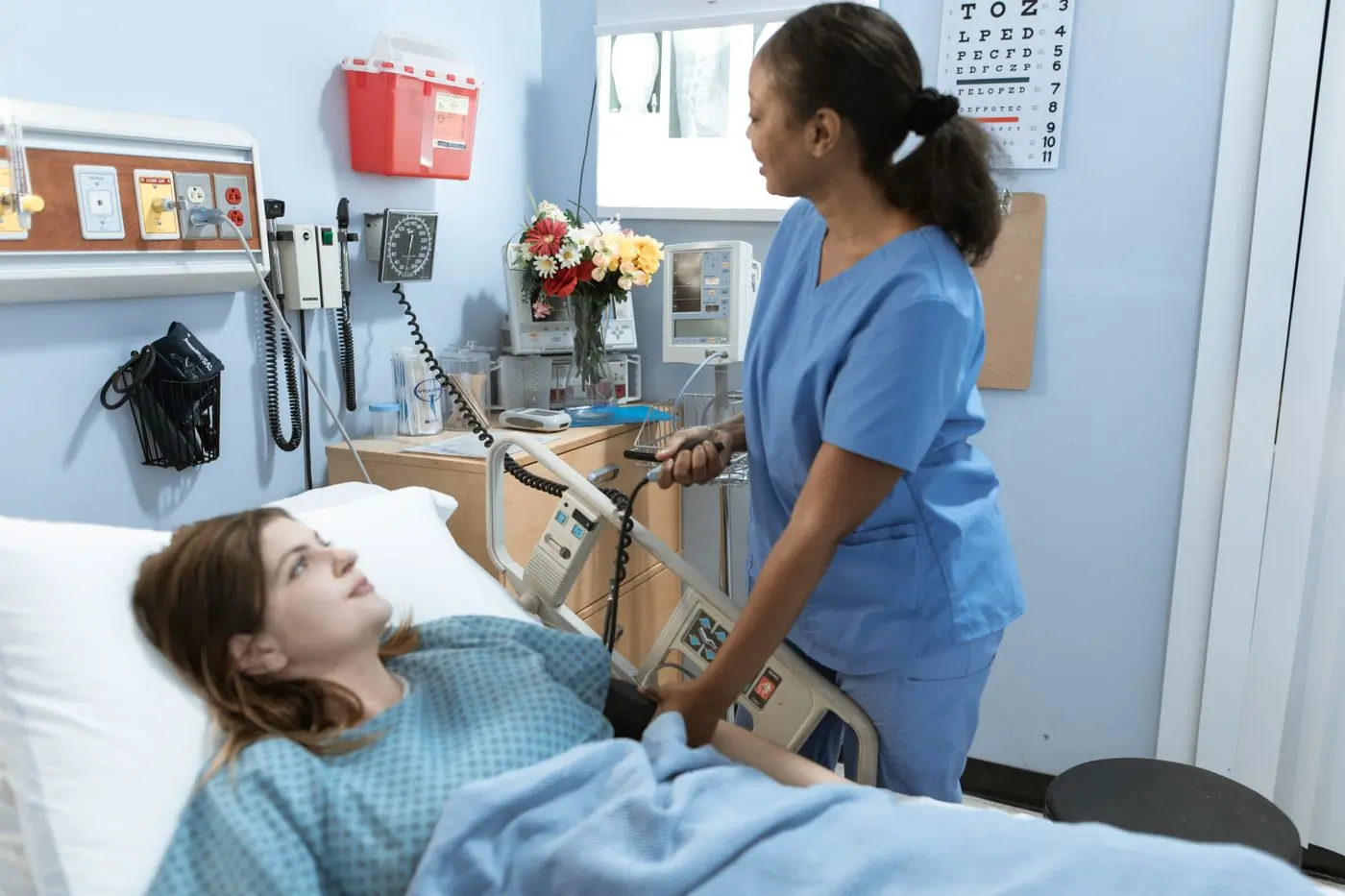 A nurse checking on a patient on the centre's ward
