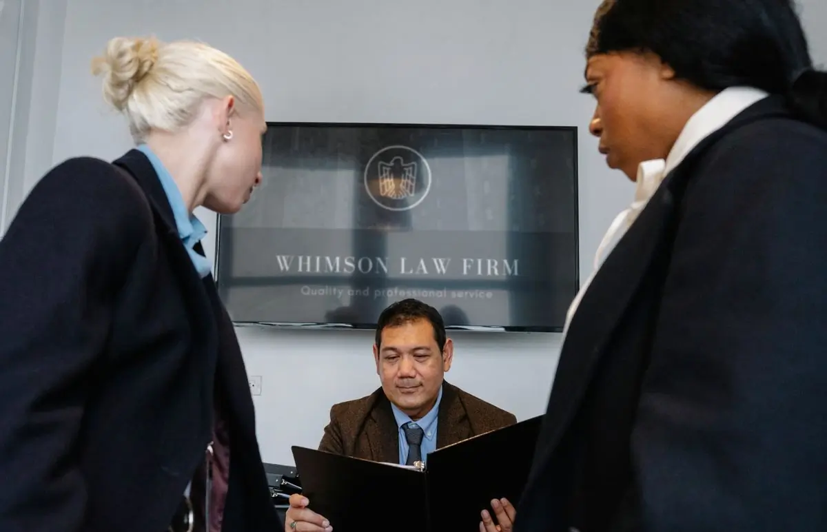 Colleagues reviewing corporate documents in a law office