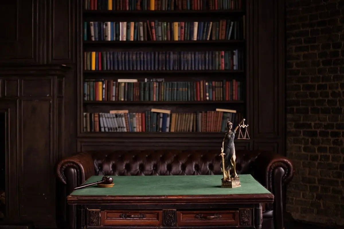 A brass figure of Justice on a chambers table