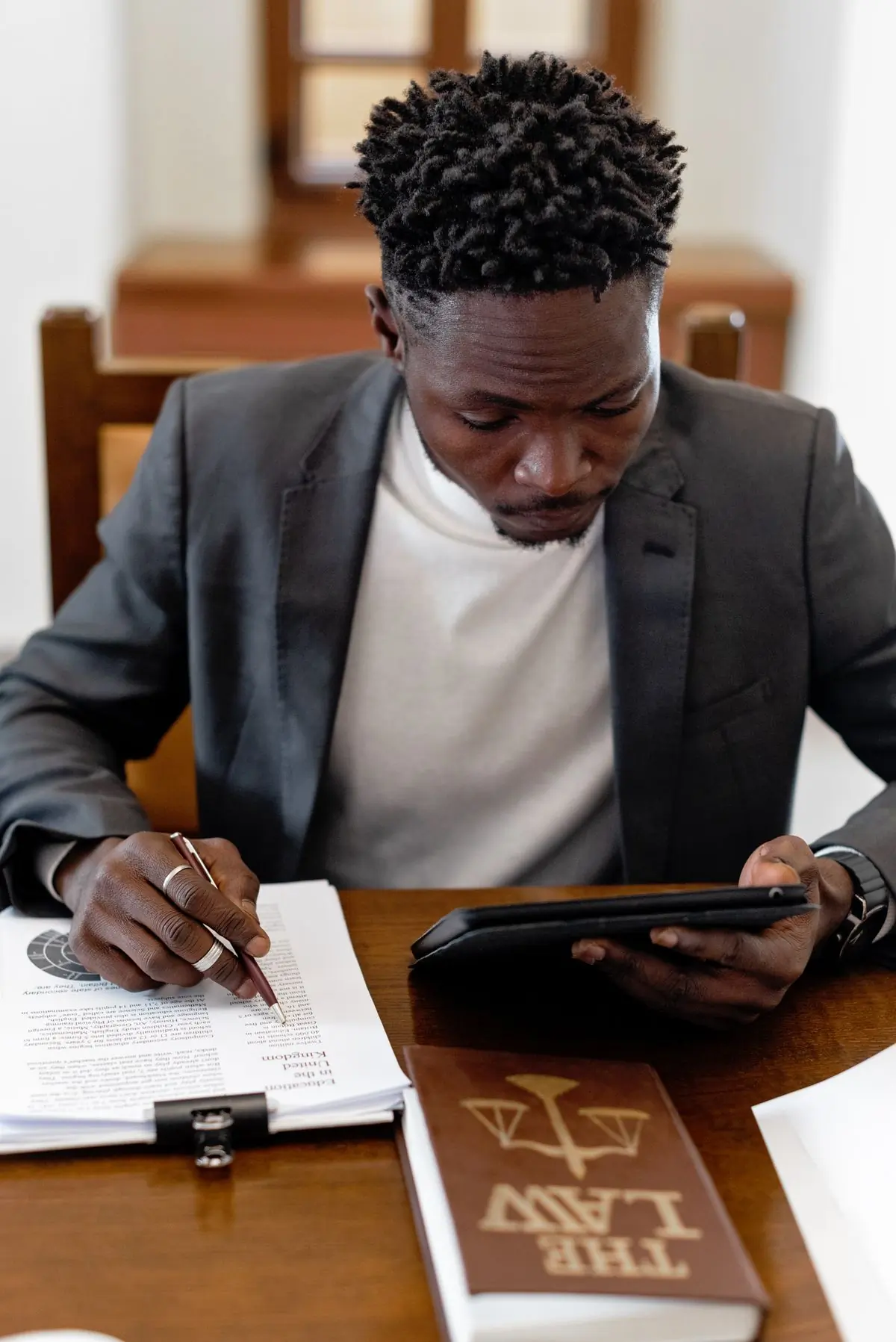 The founding partner at his desk with a brief