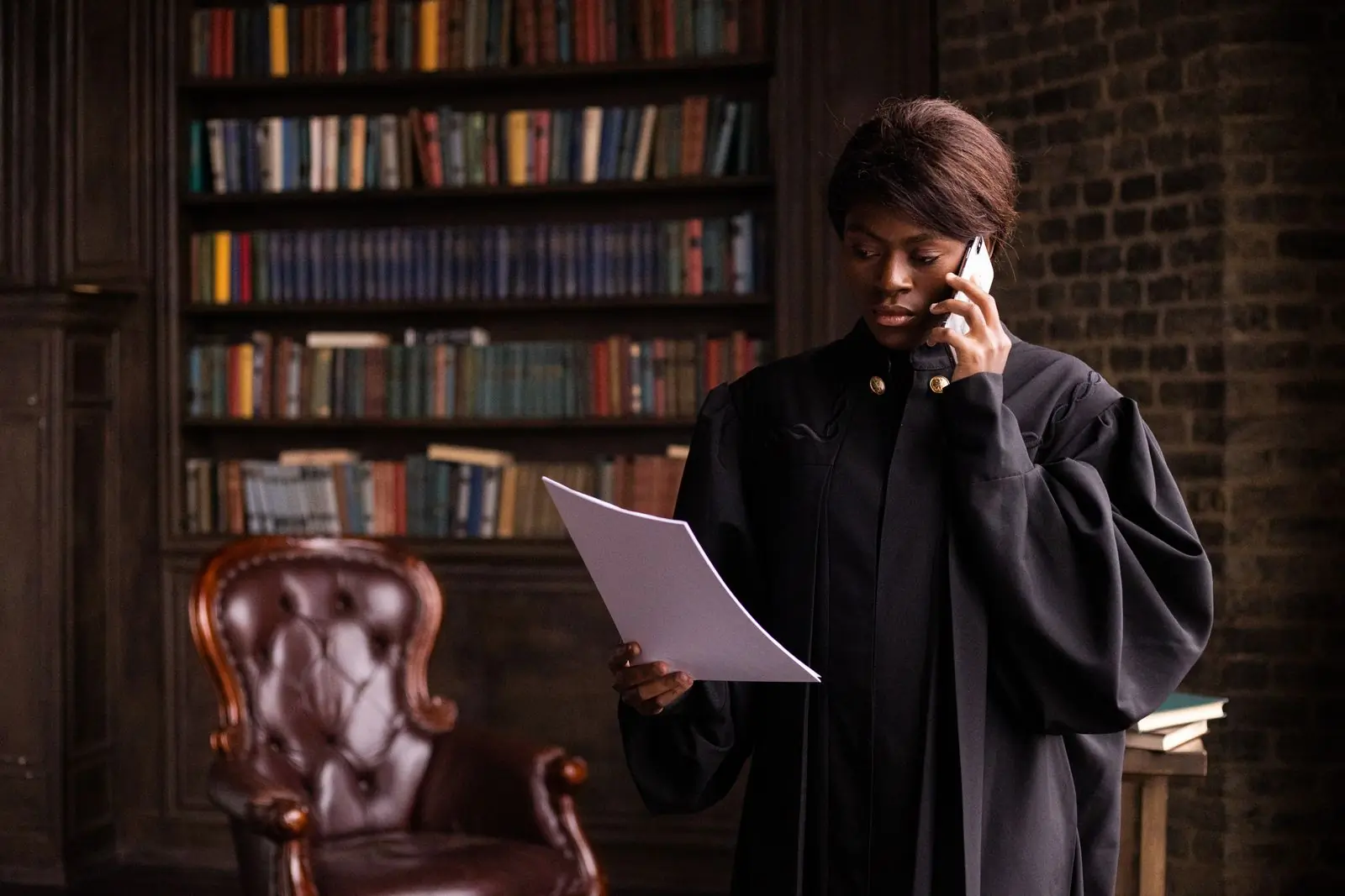 An advocate reading a brief in the firm's library