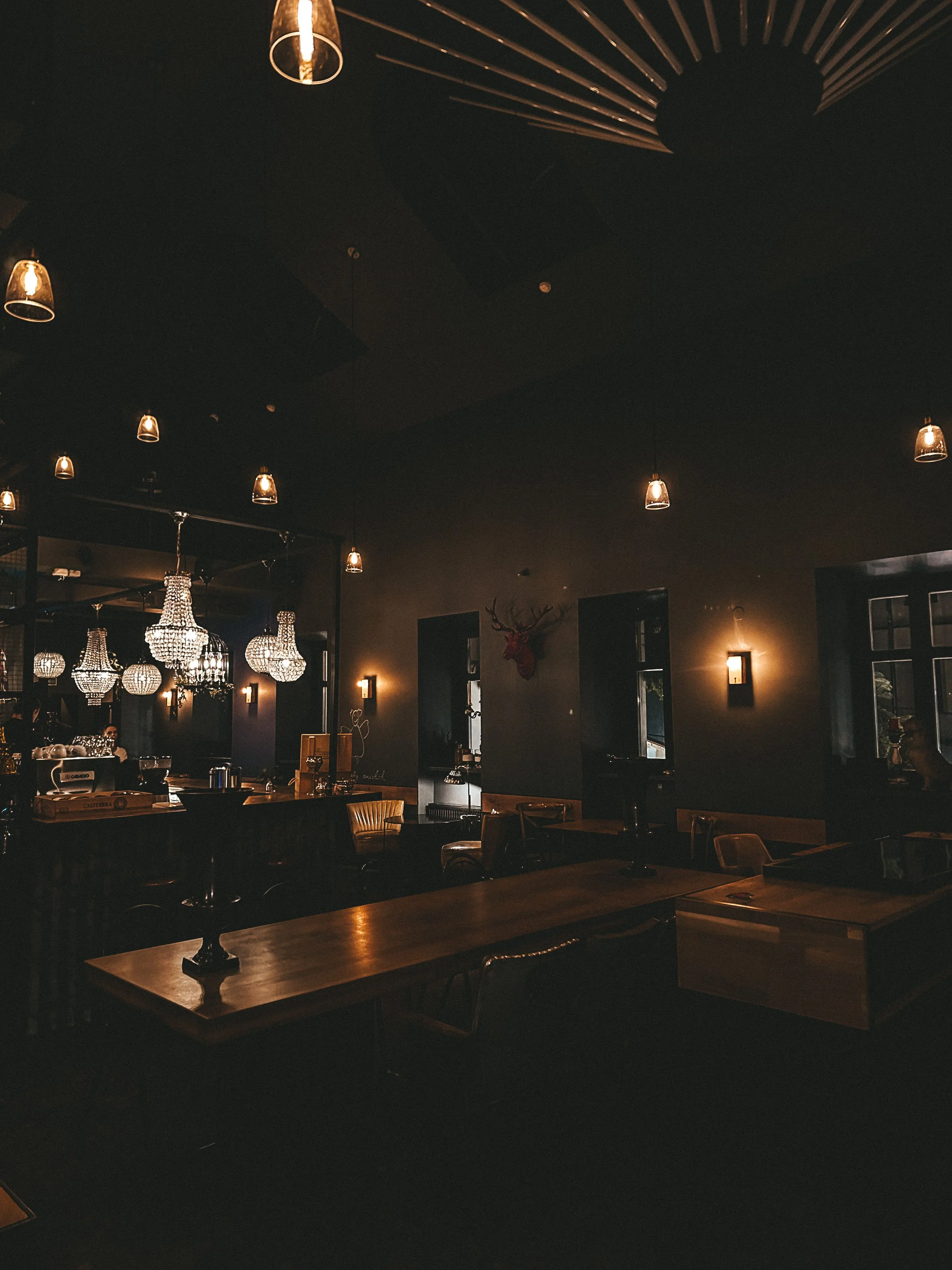 The dining room at Morsel after dark, lit by hanging lanterns