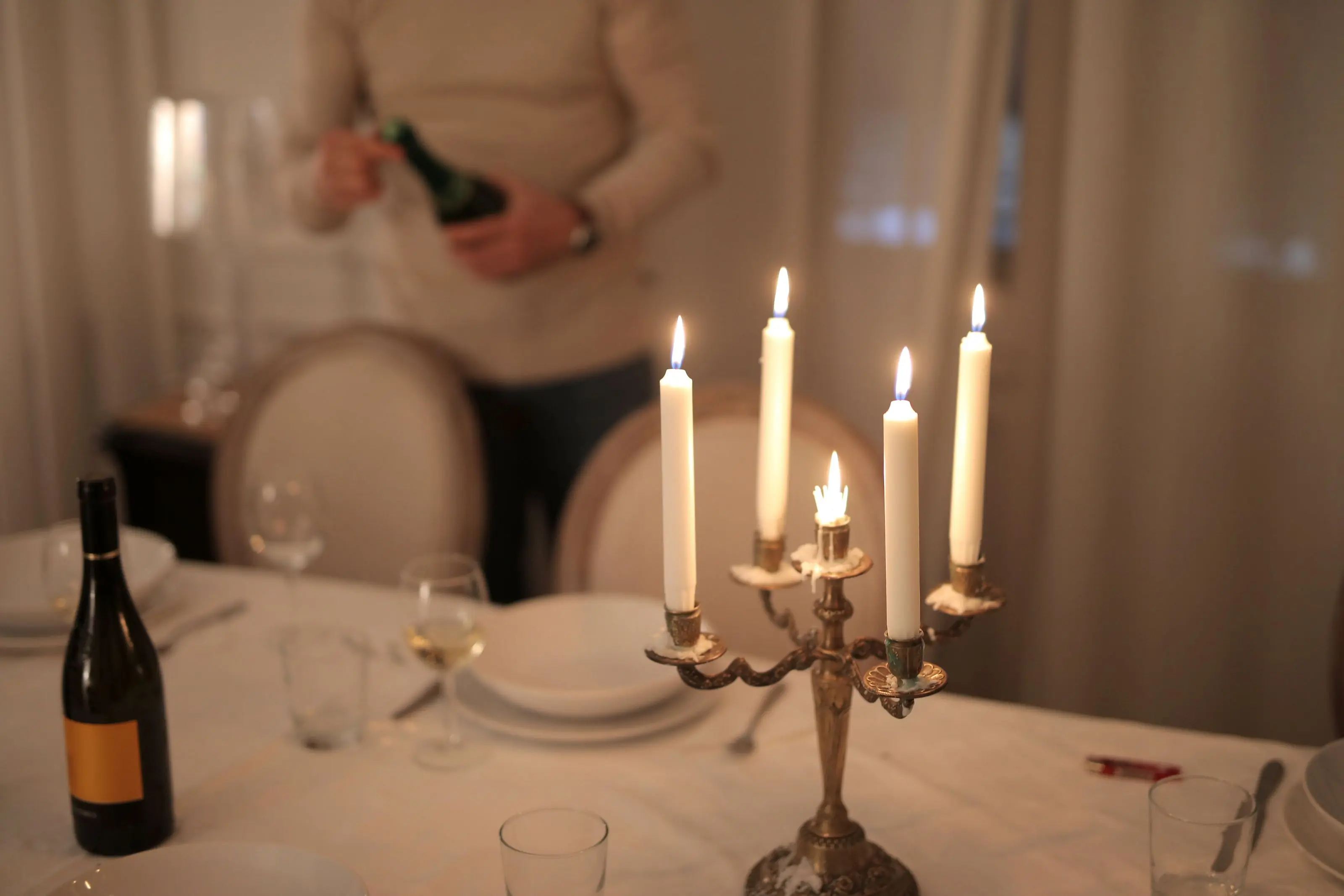 A table laid by candlelight before the doors open