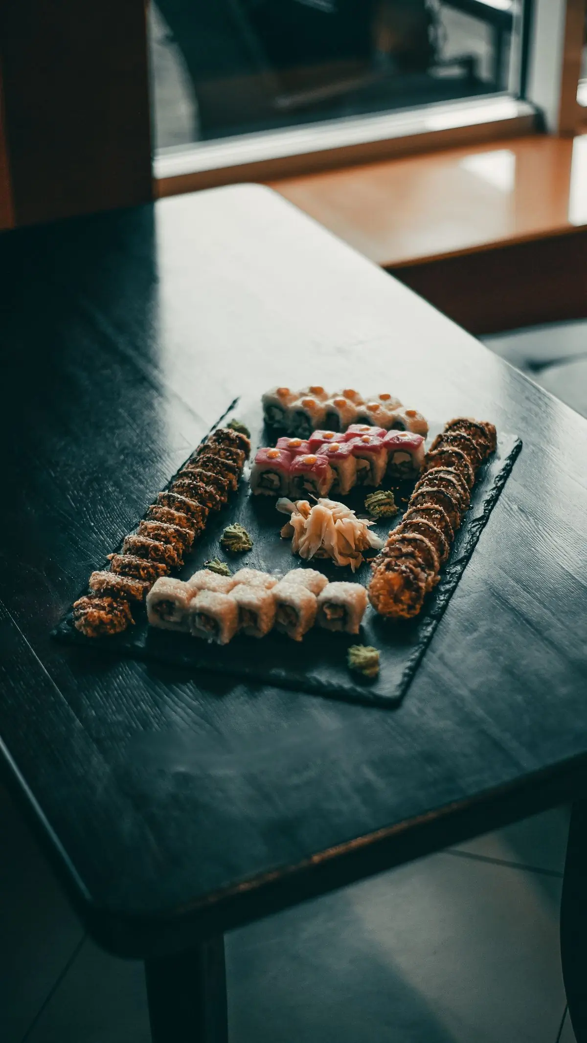 A slate tray of assorted maki rolls
