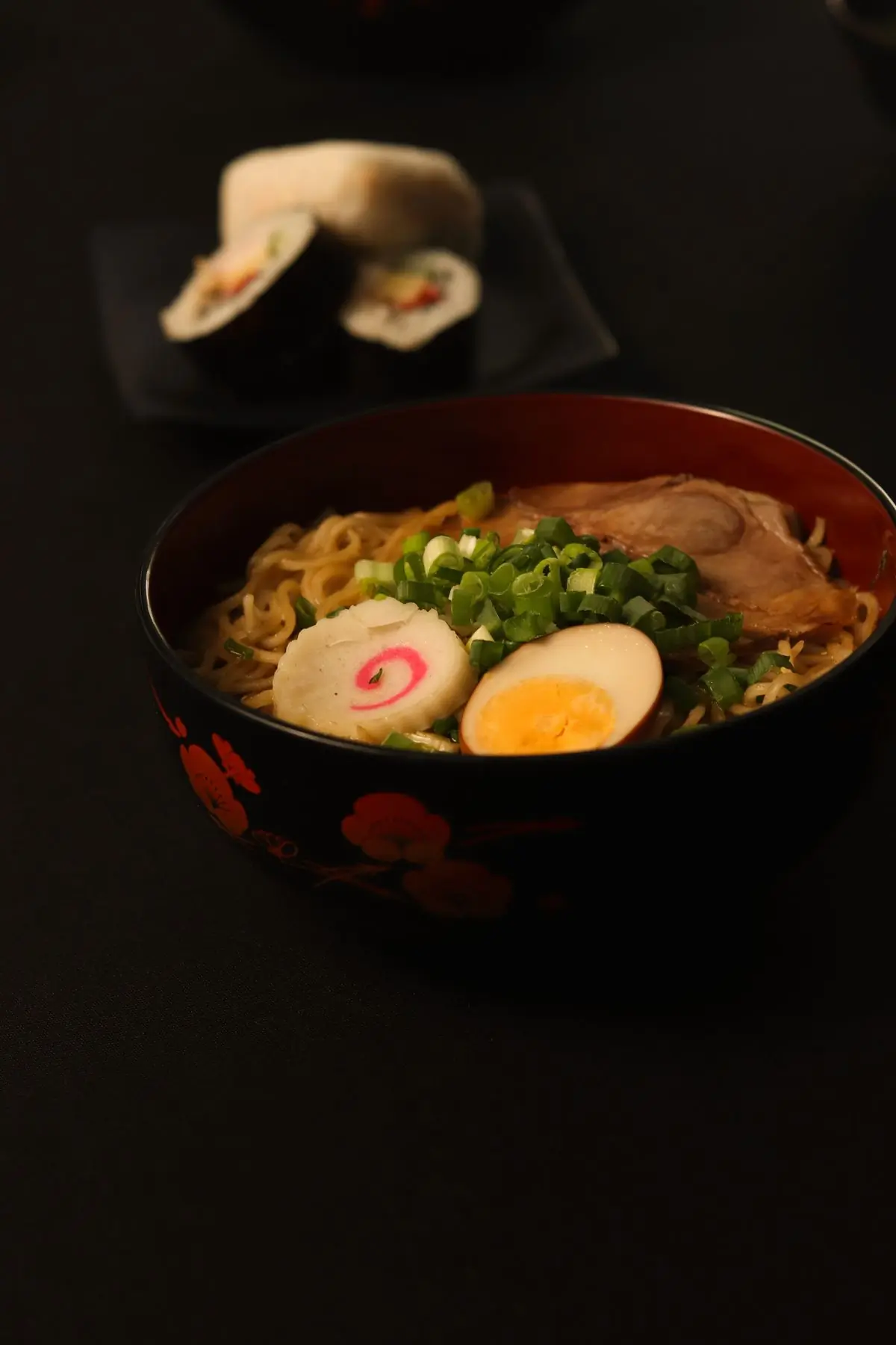 A bowl of ramen with egg and spring onion