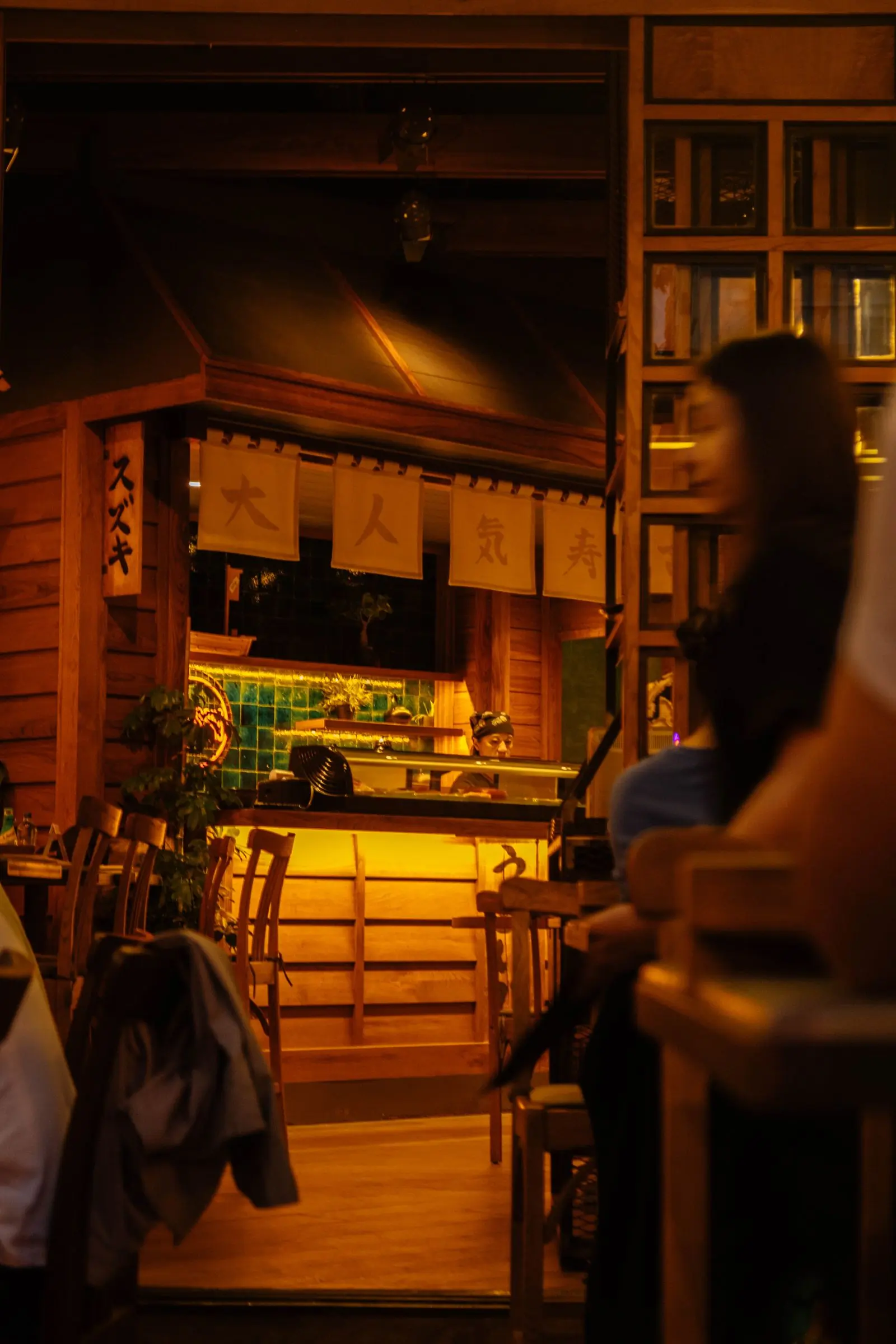 A warm lantern-lit dining room in the evening