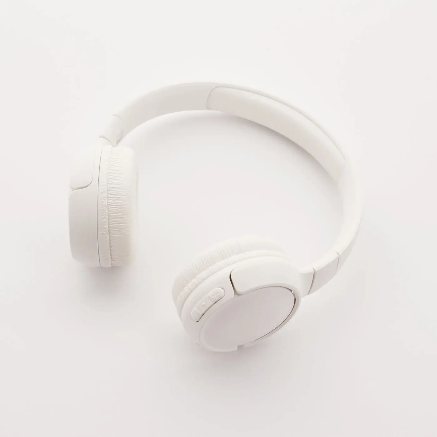 White wireless headphones seen from above on white