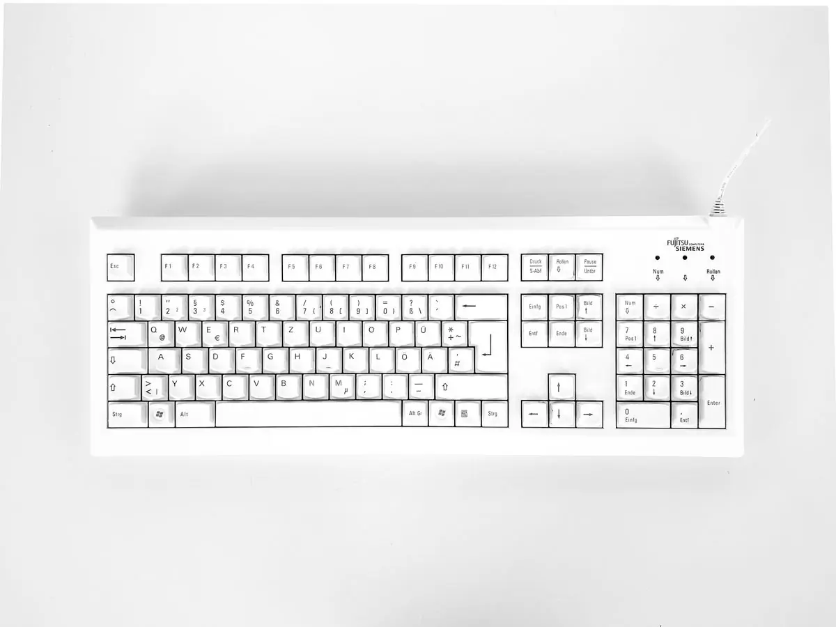 A white mechanical keyboard photographed on white