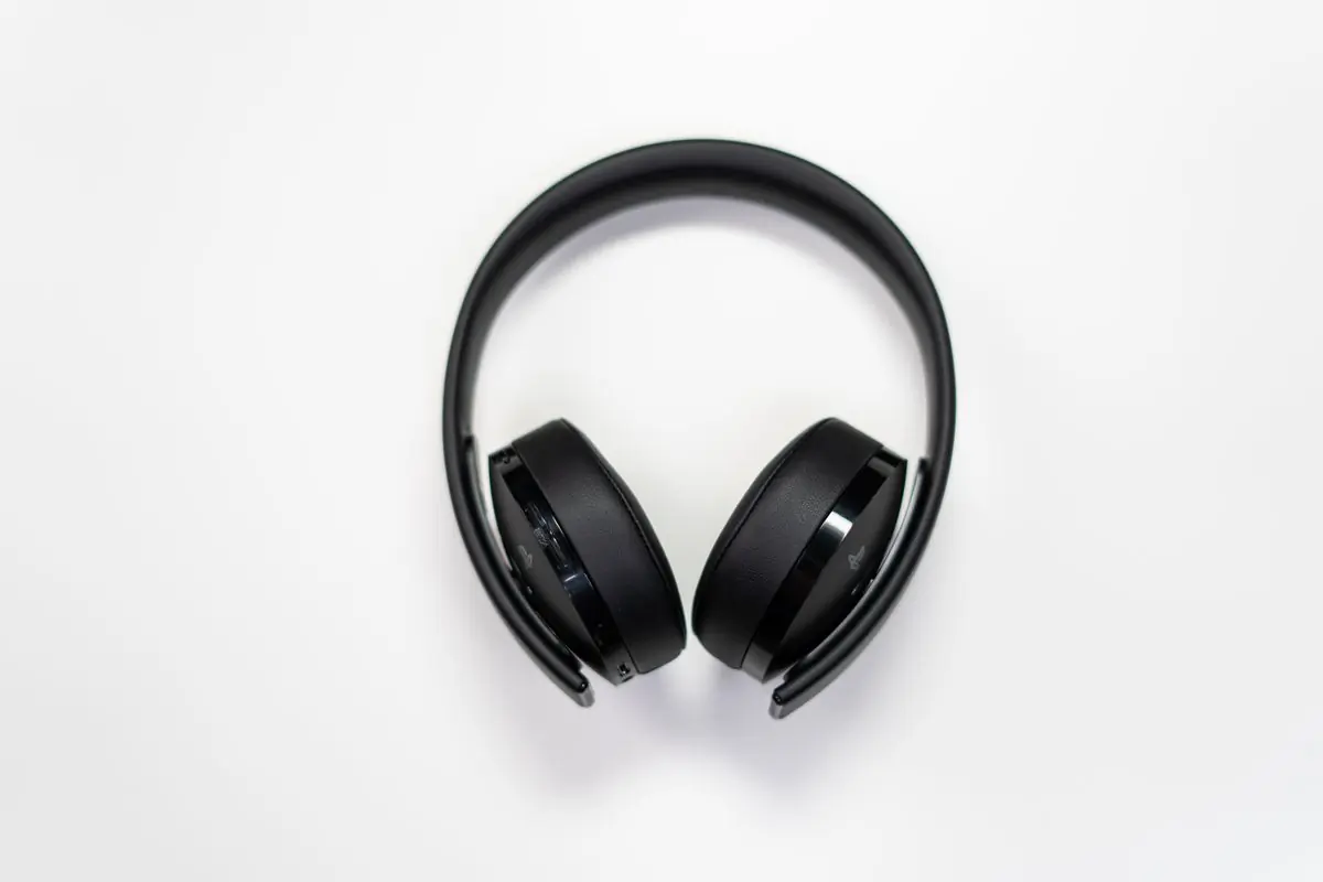 Black over-ear headphones resting on a white surface