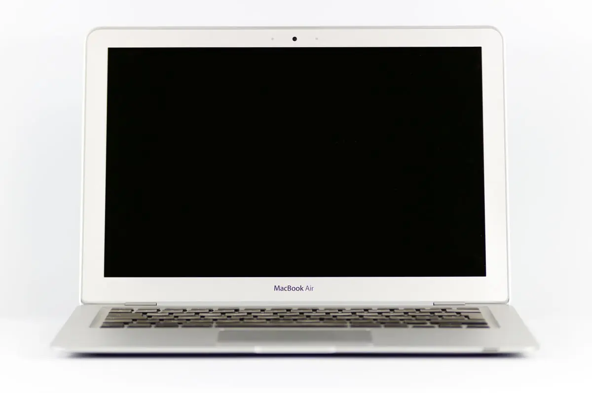 A silver ultrabook seen front on with a blank screen, on white