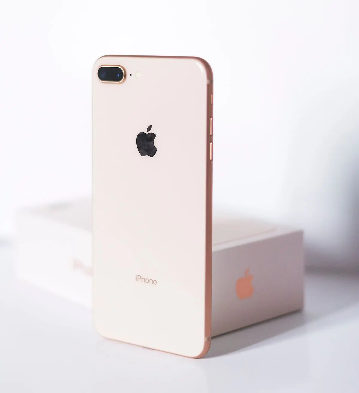 A white smartphone standing against a plain white backdrop