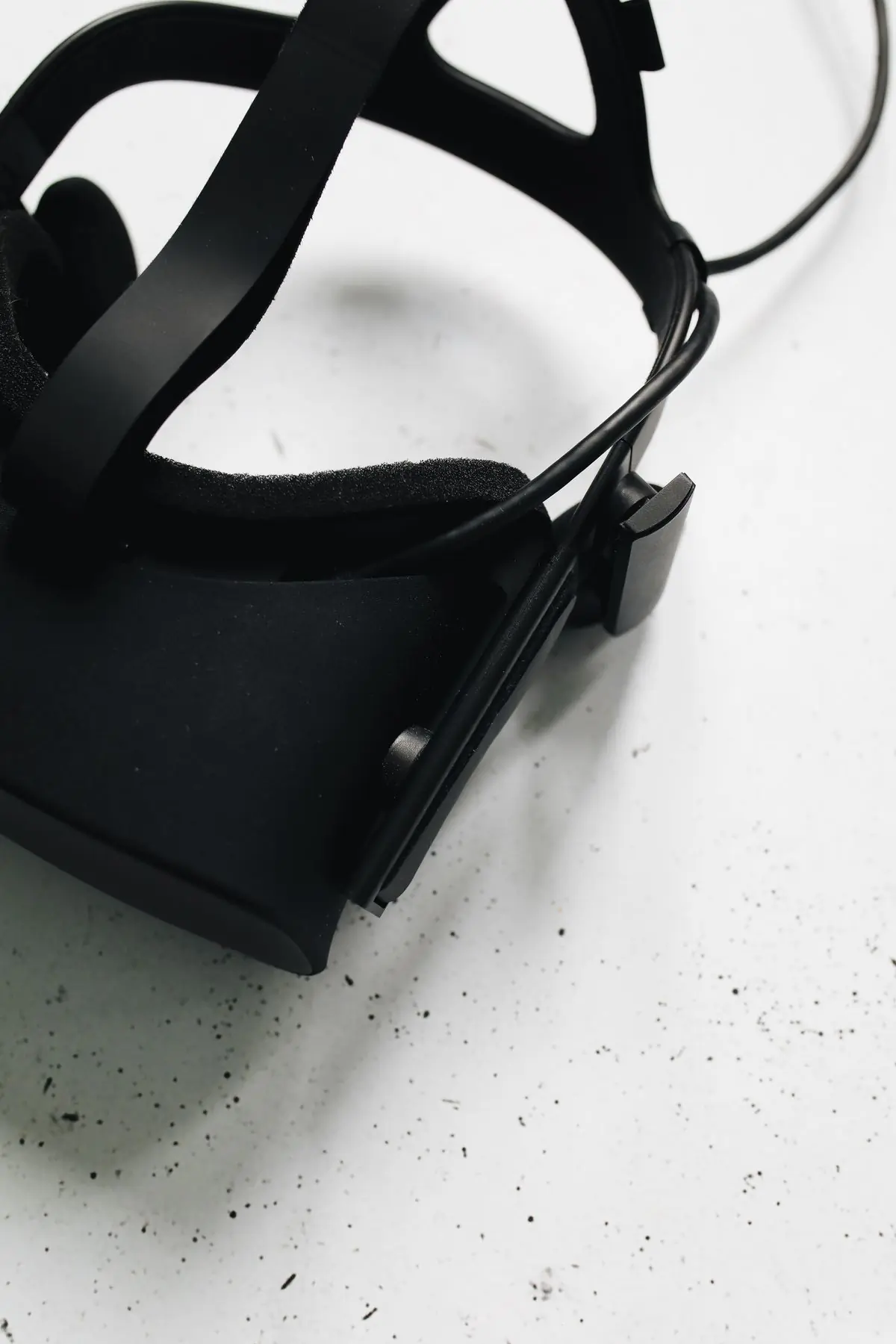 A black virtual reality headset on a white ground