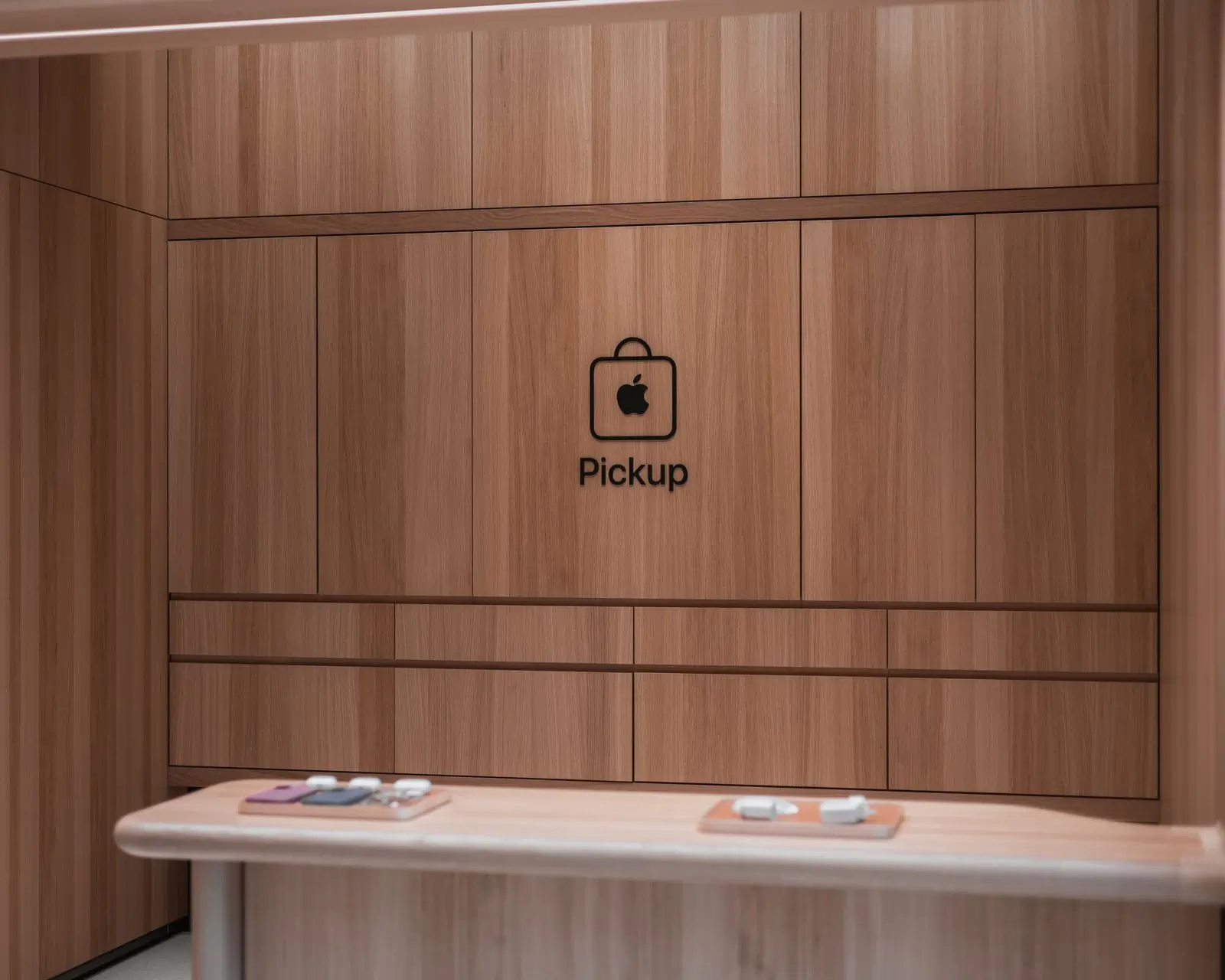 A pale wood service counter in a modern electronics shop