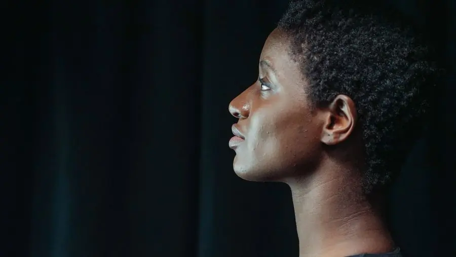 Abena Owusu-Ansah in profile against a black ground