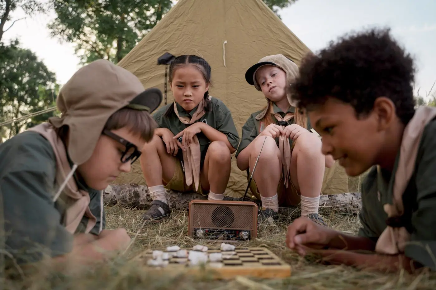 Campers playing a board game on a rug during the quiet hour