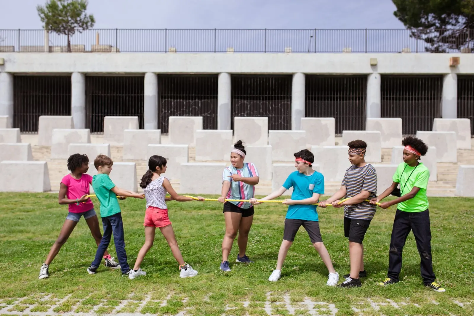 Campers and staff mid tug of war on the top field