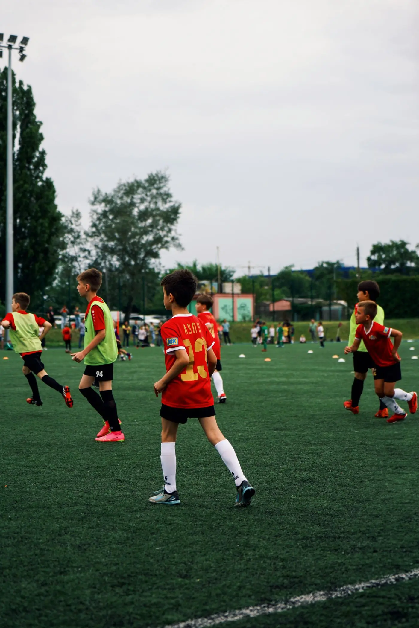 Campers in training bibs working through a passing drill