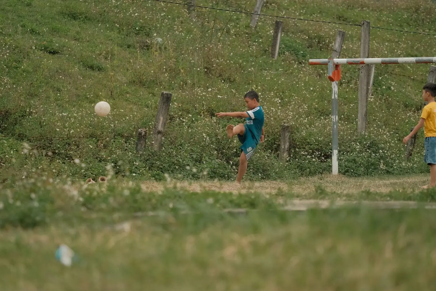 A camper striking a ball across the top pitch