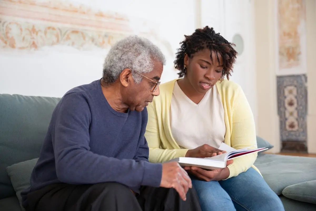 A nurse sitting with a patient during a home visit