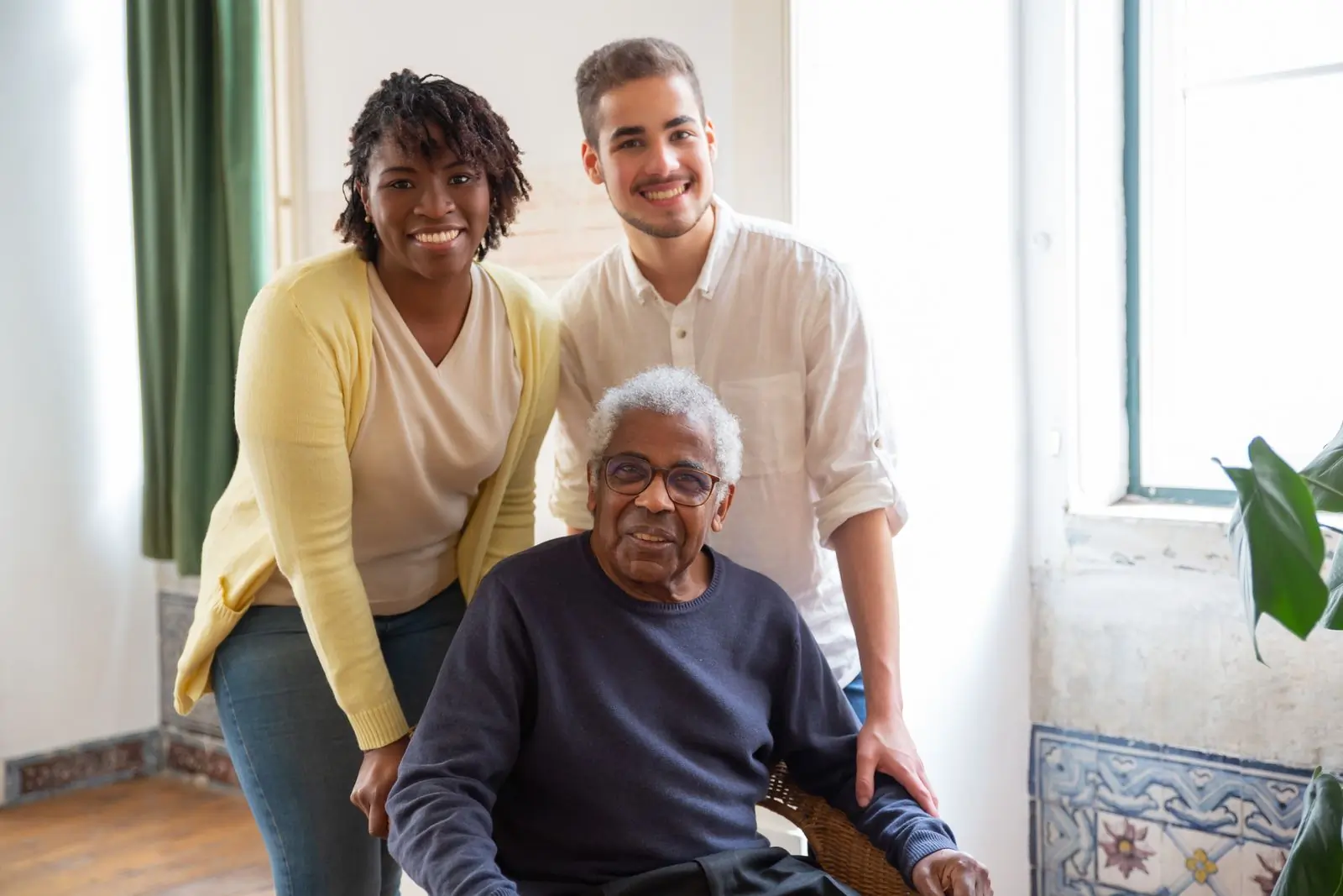 A patient of the centre at home with two of its carers