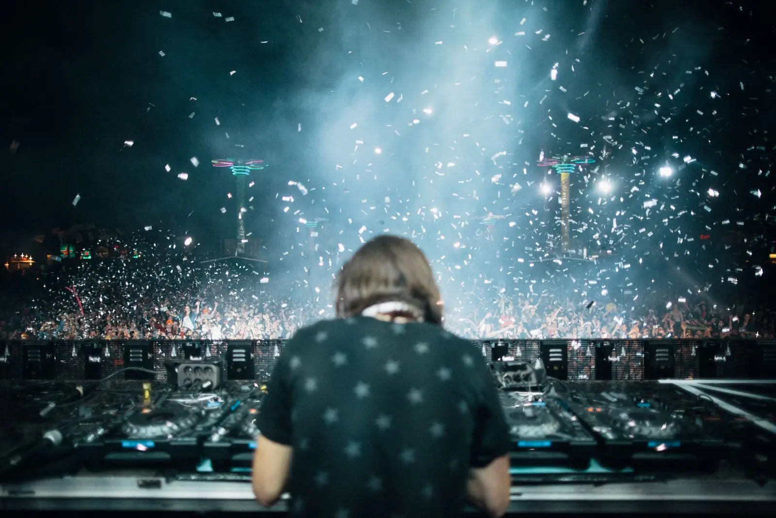 A selector seen from behind, facing a crowd under falling confetti