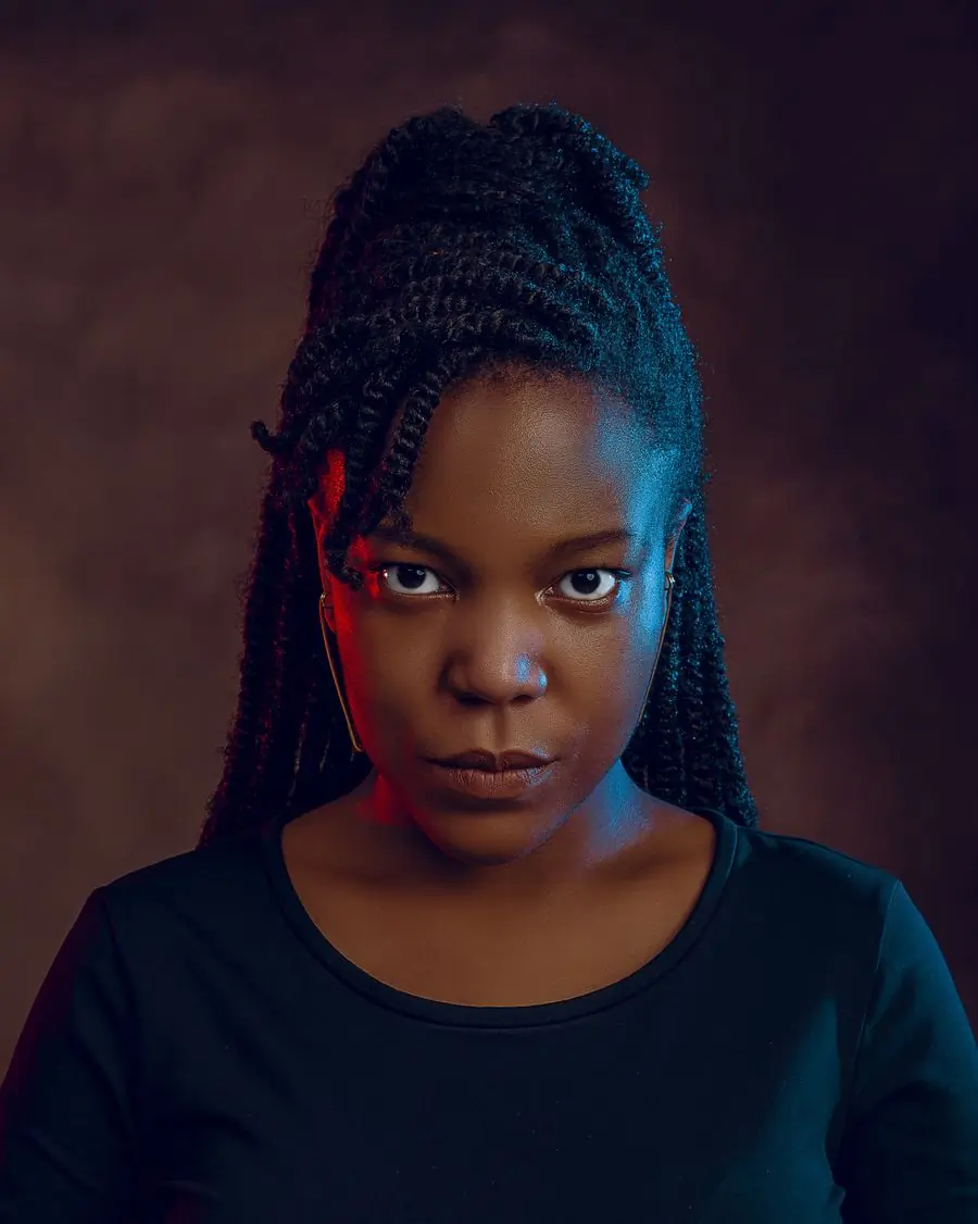 Serwaa Boateng photographed in a studio against a dark ground