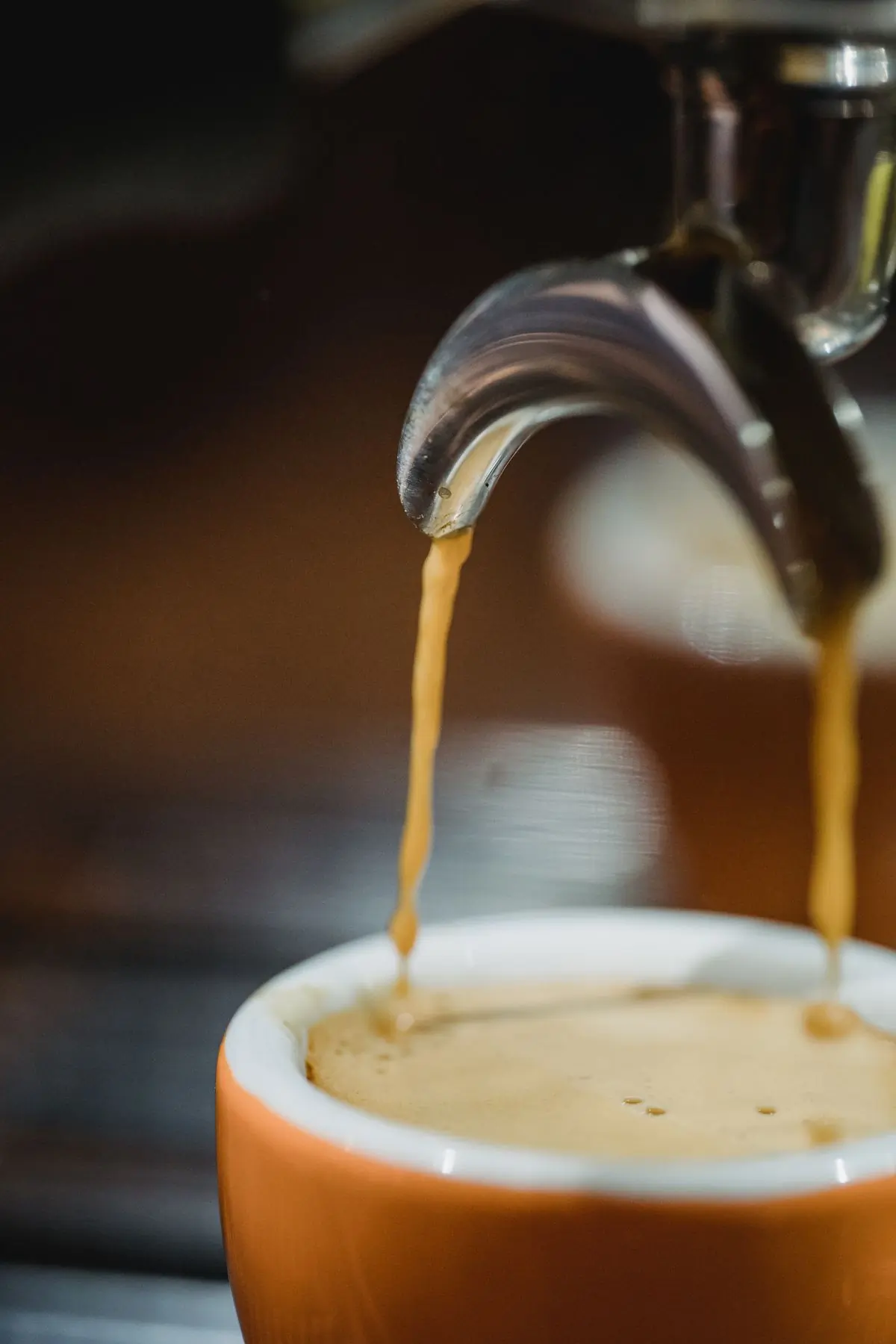 A barista pulling a shot at the counter