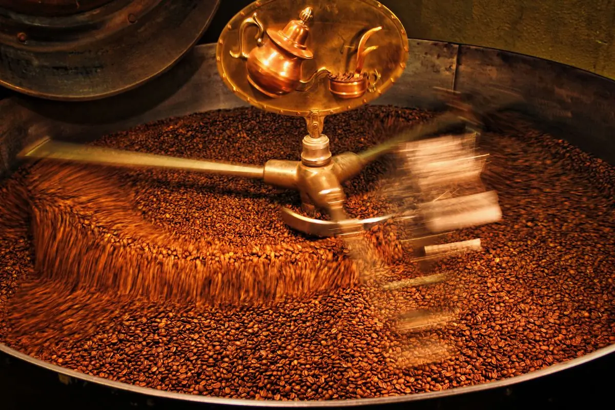 Beans tumbling in the drum of a roaster
