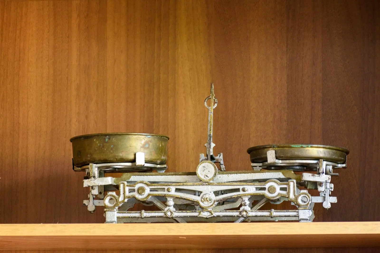 The brass balance we still weigh sample roasts on, on its shelf at the roastery