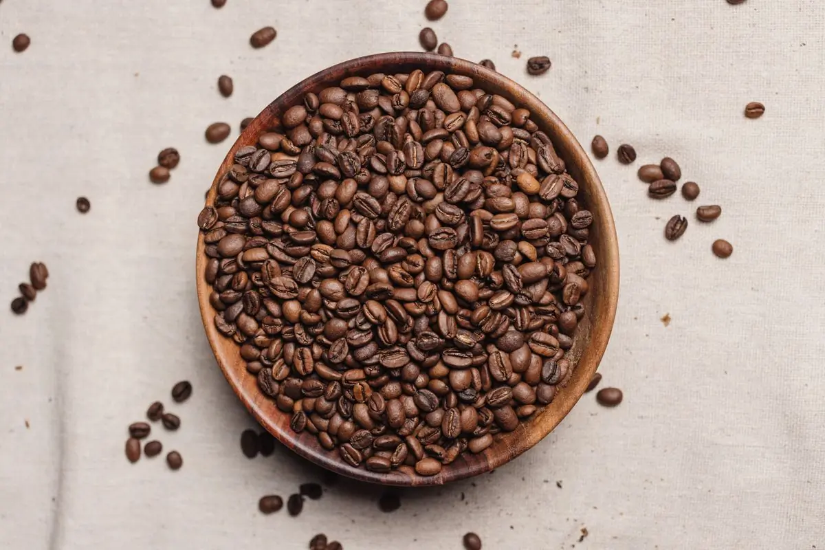 Roasted whole beans in a shallow bowl, seen from above