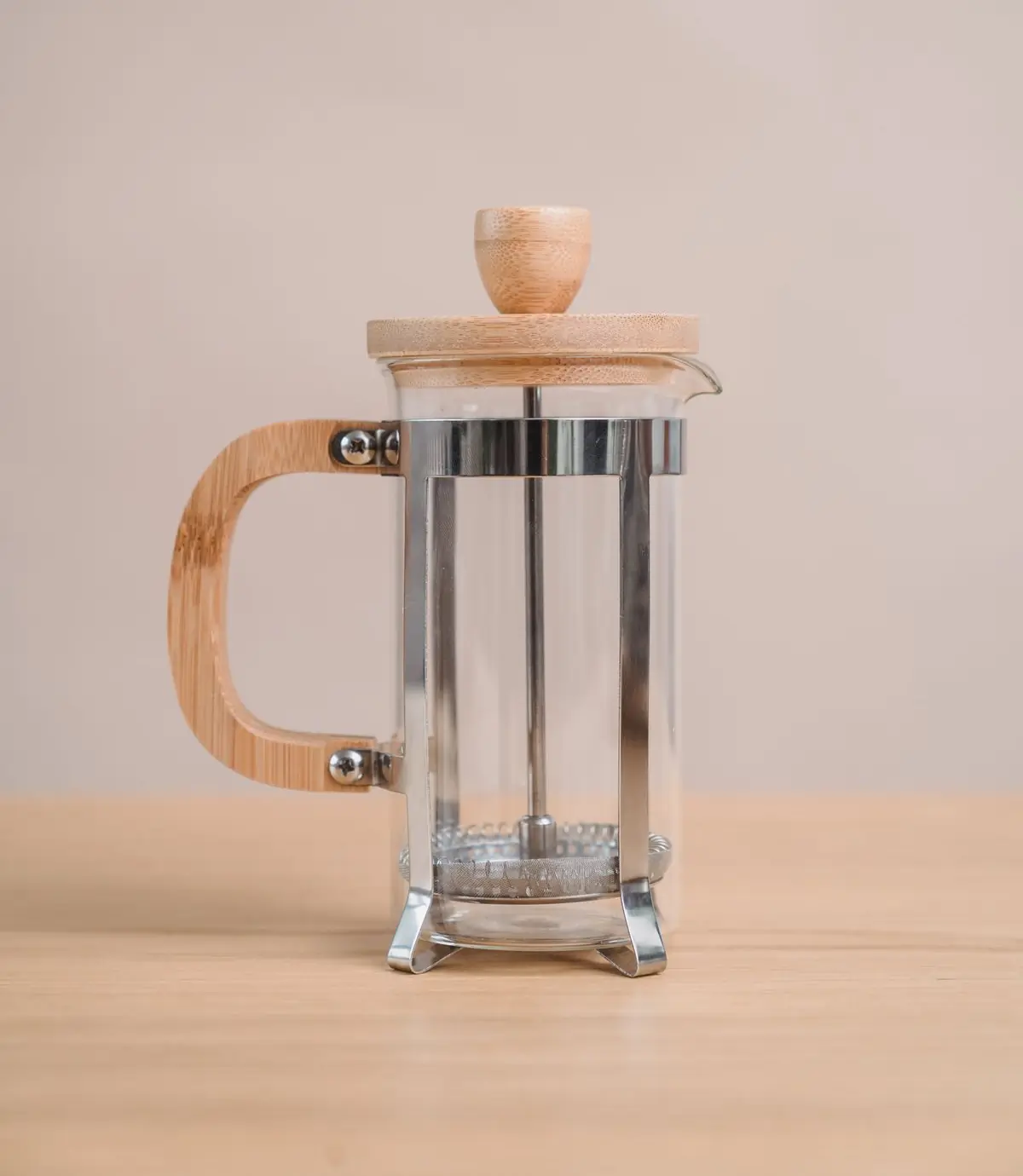 A glass cafetière on a plain ground