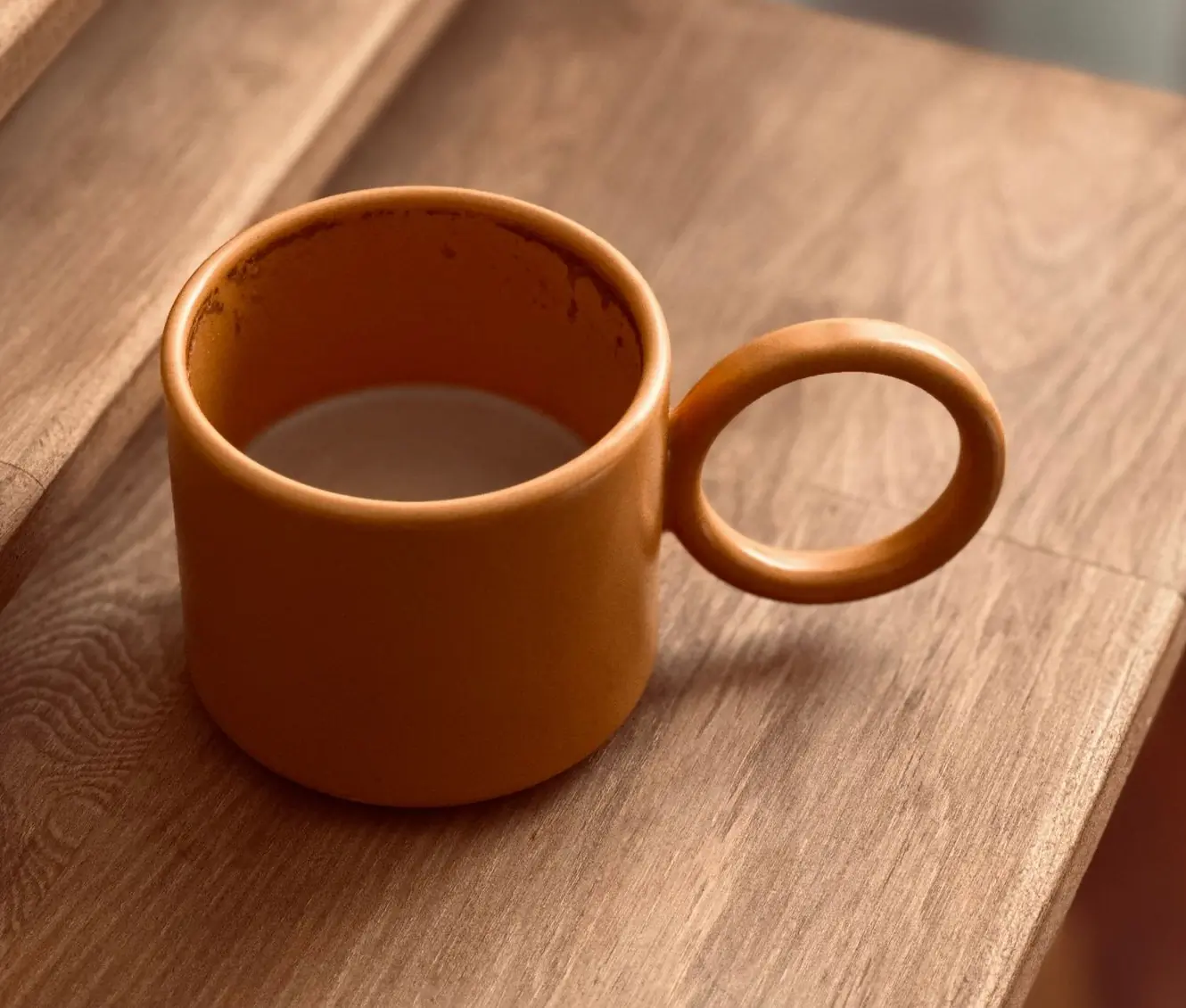 A stoneware mug on a plain ground