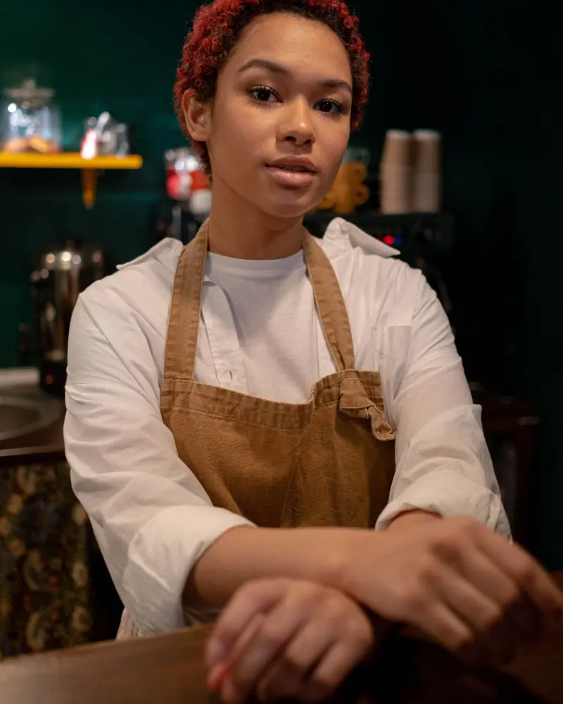 Ama behind the counter at the Osu shop in her work apron