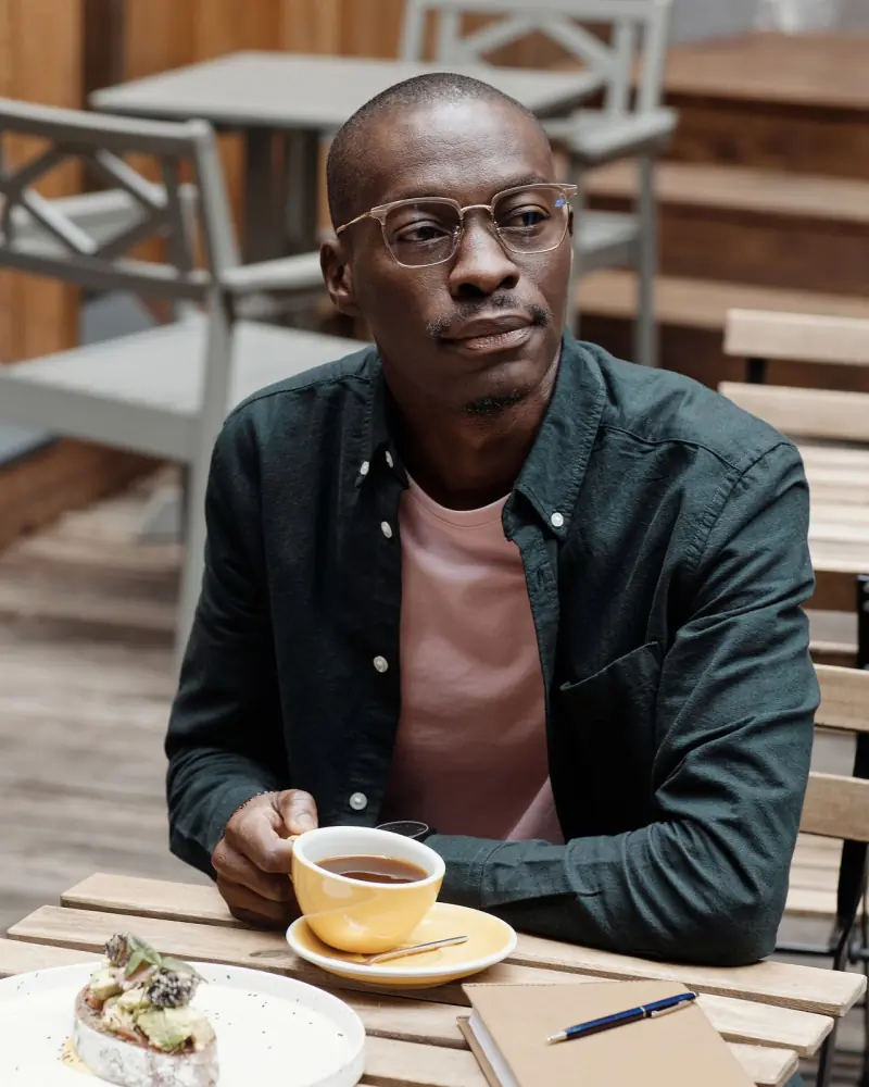 A customer at the counter with a bag of beans