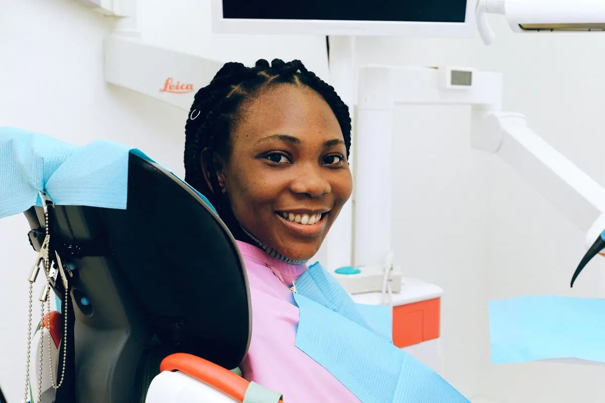 A patient smiling in the chair after a check-up